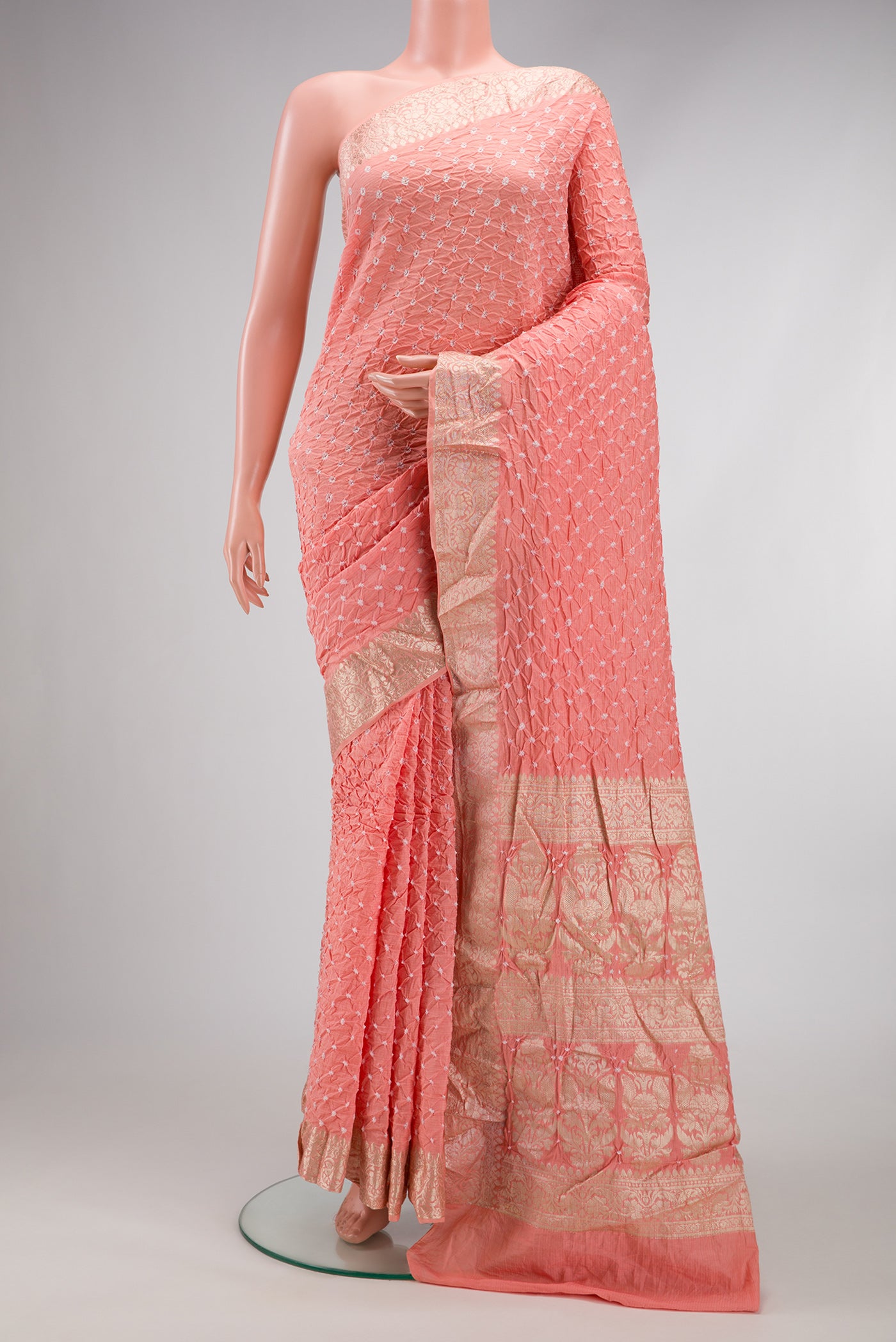 Peach Dual Tone Blended Bandhani Silk Saree with Bandhani Print on the body and Zari Border.  displayed on a mannequin