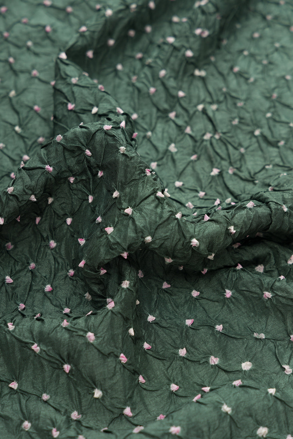 Close up of Mehandi Green Dual Tone Bandhani Silk Saree with Bandhani Print on the body and Paithani Border.  displaying folds