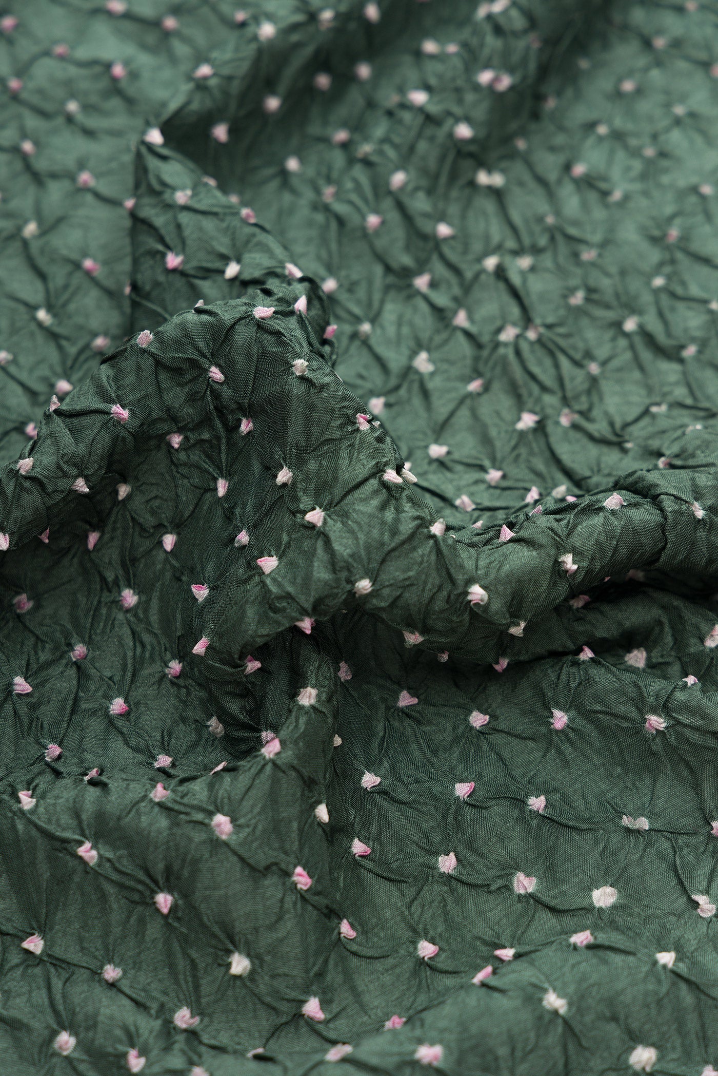 Close up of Mehandi Green Dual Tone Bandhani Silk Saree with Bandhani Print on the body and Paithani Border.  displaying folds