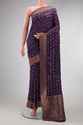 Purple Blended Bandhani Silk Saree with Bandhani Print on the body and Zari Border.  displayed on a mannequin