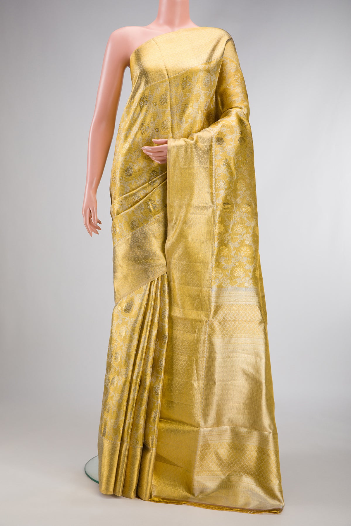 Gold Dual Tone Kanjivaram Tissue Silk Saree with Zari Brocade on the body and Zari Border.  displayed on a mannequin