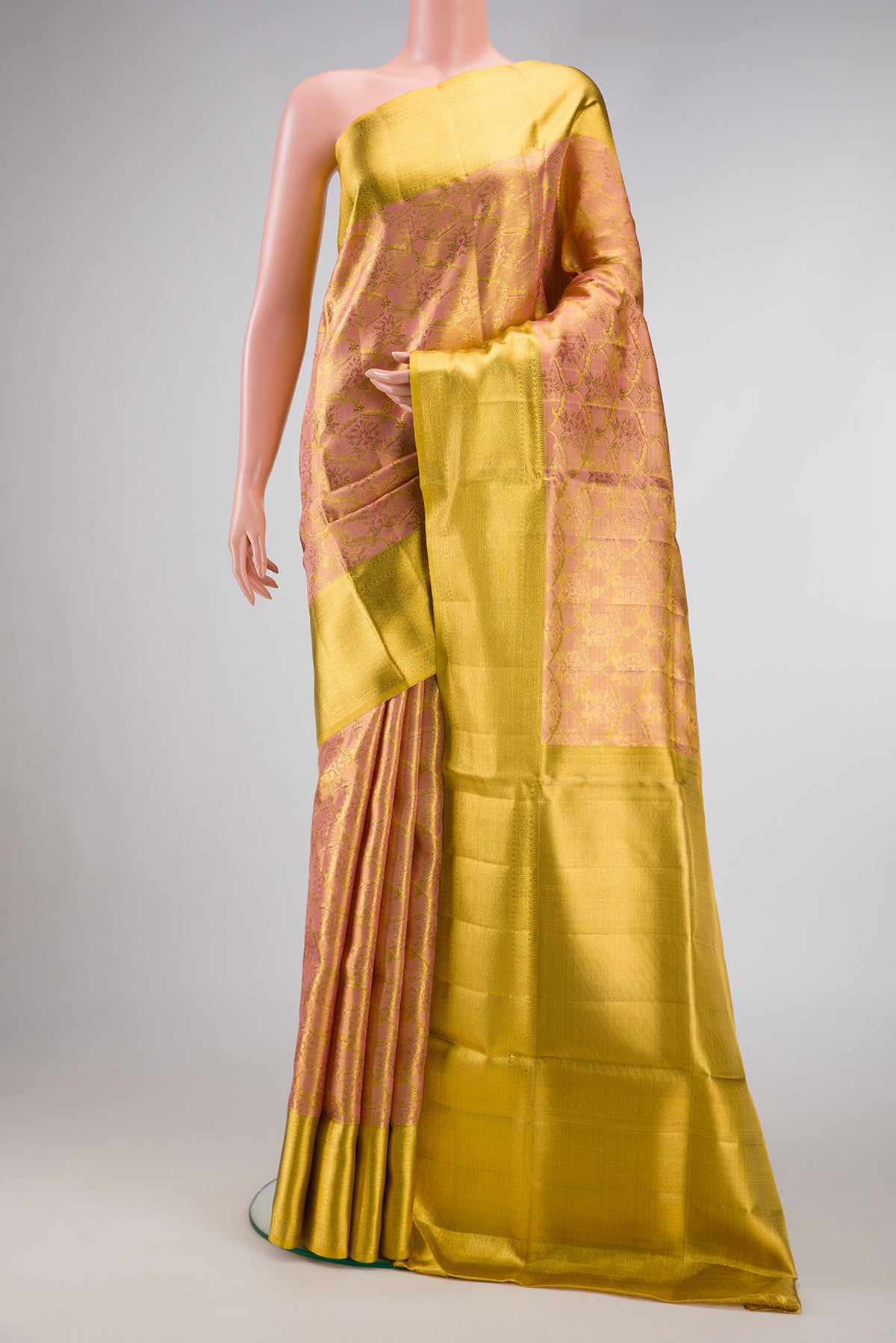 Rose Gold Dual Tone Kanjivaram Tissue Silk Saree with Zari Brocade on the body and Zari Border.  displayed on a mannequin