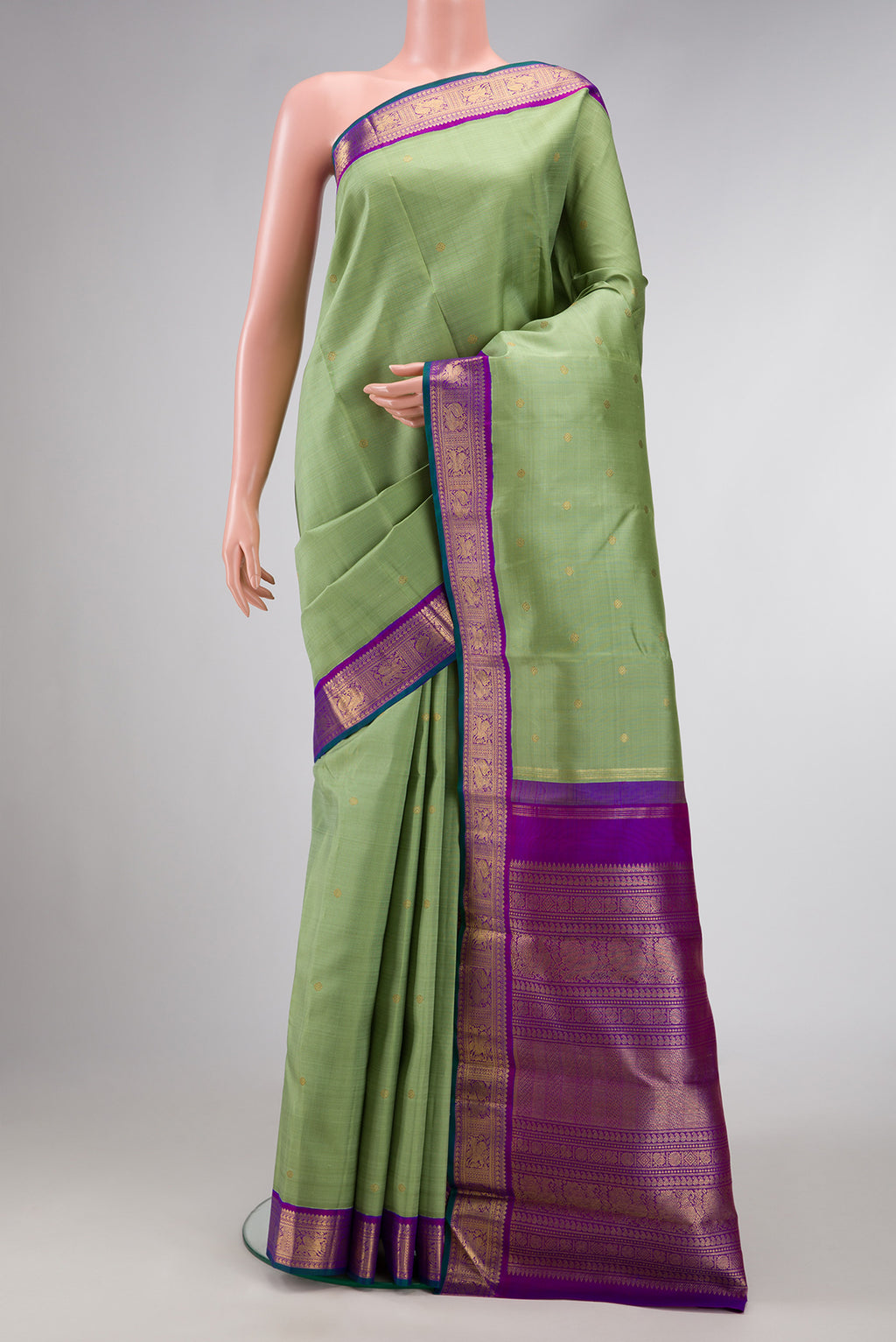 Pure Silk Pure Zari Pista Green Dual Tone Kanjivaram Saree with Zari Butta on the body and Zari Border.  displayed on a mannequin