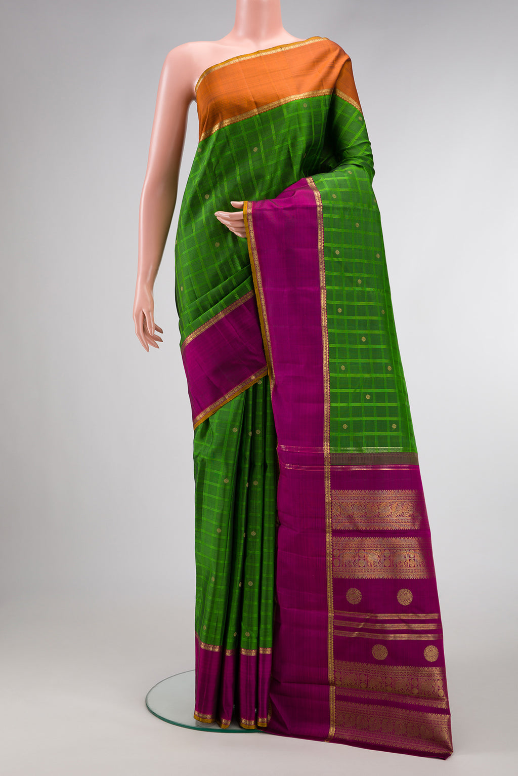 Pure Silk Pure Zari Green Dual Tone Kanchipuram Saree with Checked design on the body and Ganga Jamuna Border.  displayed on a mannequin
