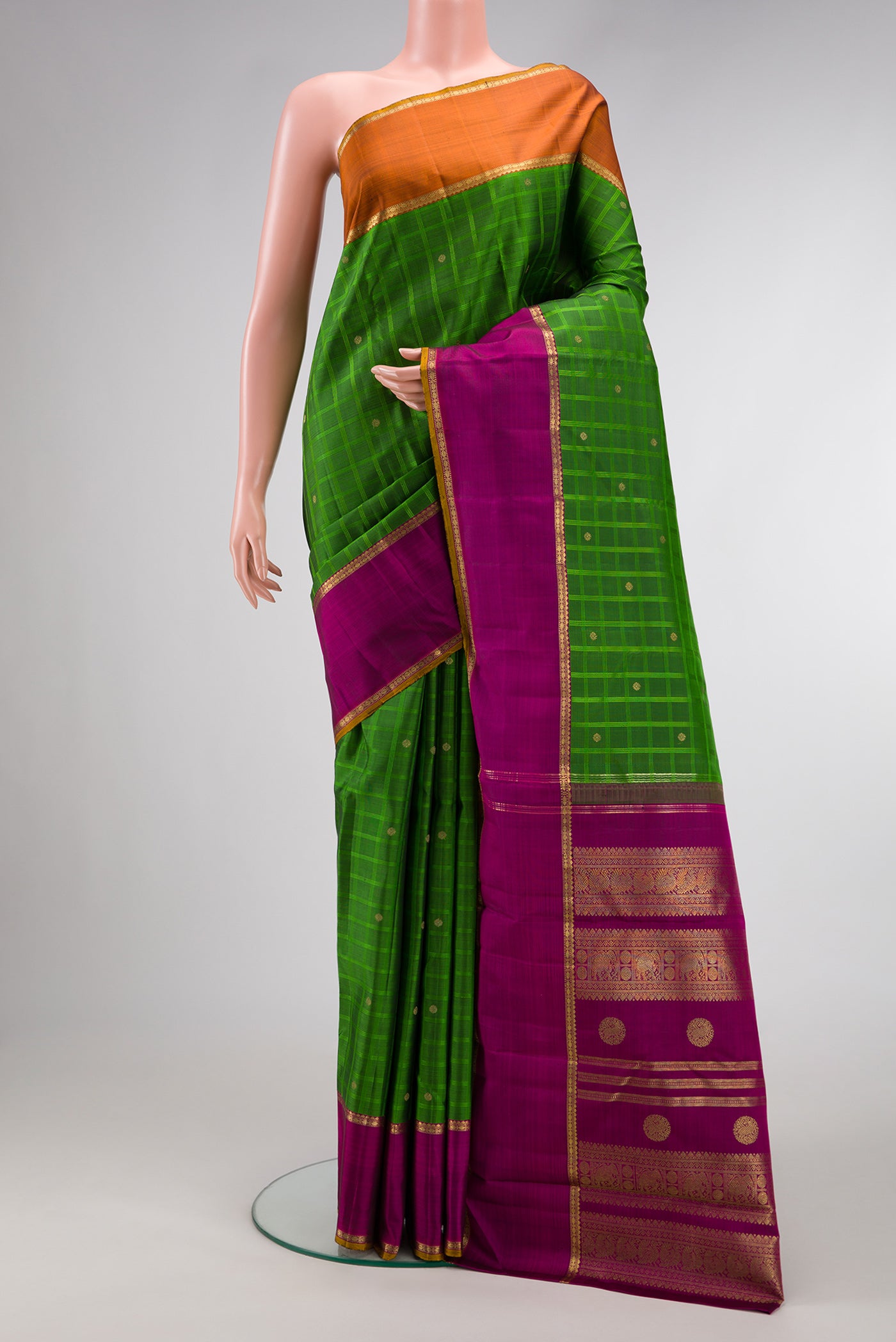 Pure Silk Pure Zari Green Dual Tone Kanchipuram Saree with Checked design on the body and Ganga Jamuna Border.  displayed on a mannequin