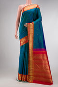 Pure Silk Pure Zari Peacock Blue Dual Tone Kanjivaram Saree with Zari Butta on the body and Zari Border.  displayed on a mannequin