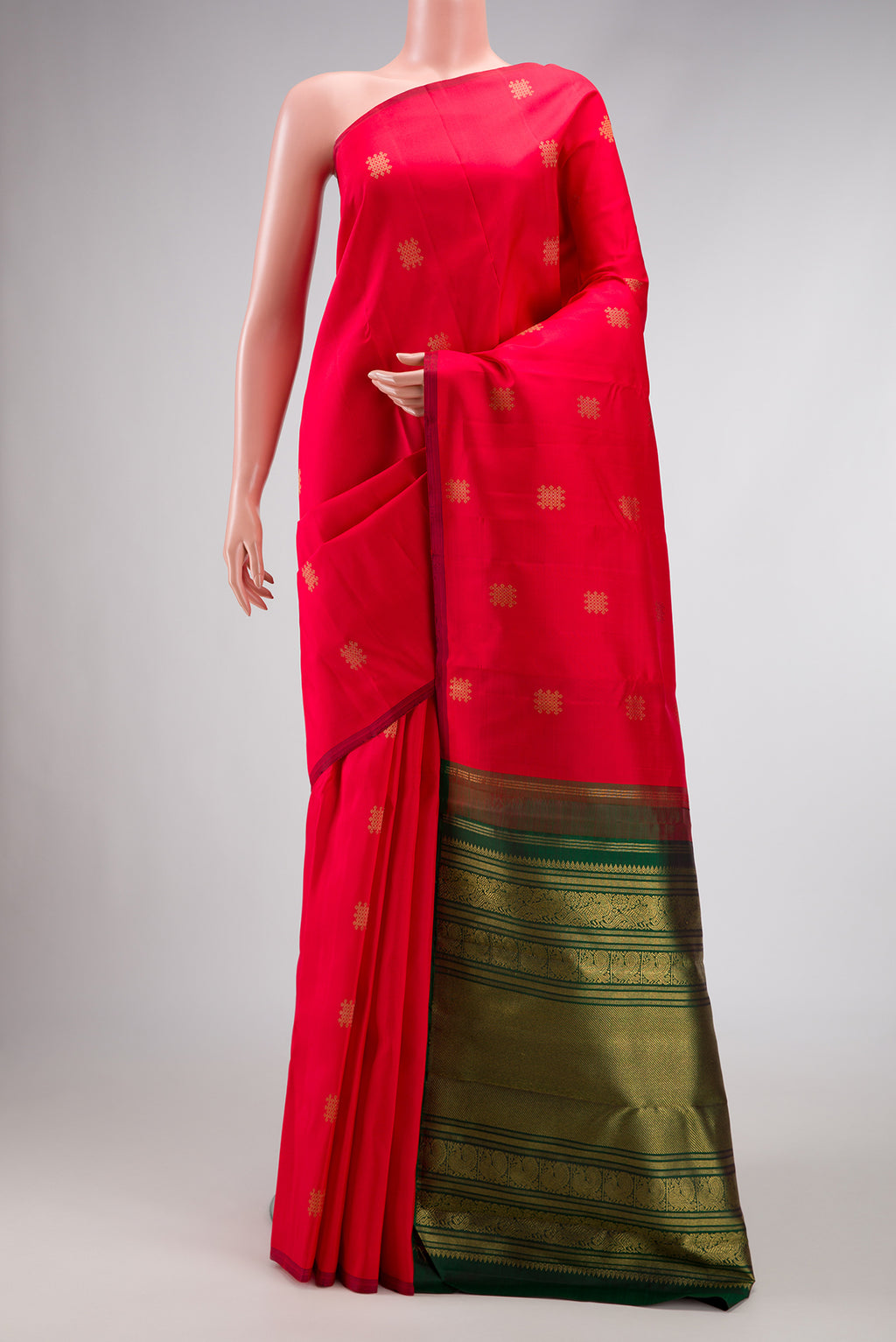 Red Dual Tone Kanchipuram Silk Saree with Zari Butta on the body and Without Border.  displayed on a mannequin