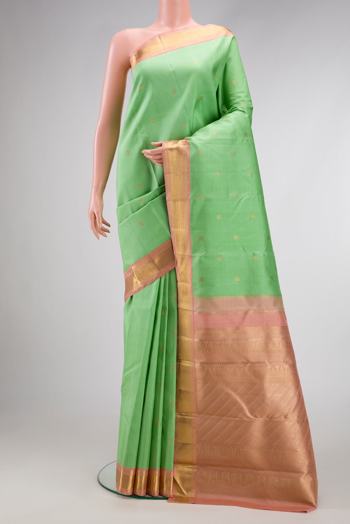 Light Green Dual Tone Kanjivaram Silk Saree with Zari Butta on the body and Zari Border.  displayed on a mannequin