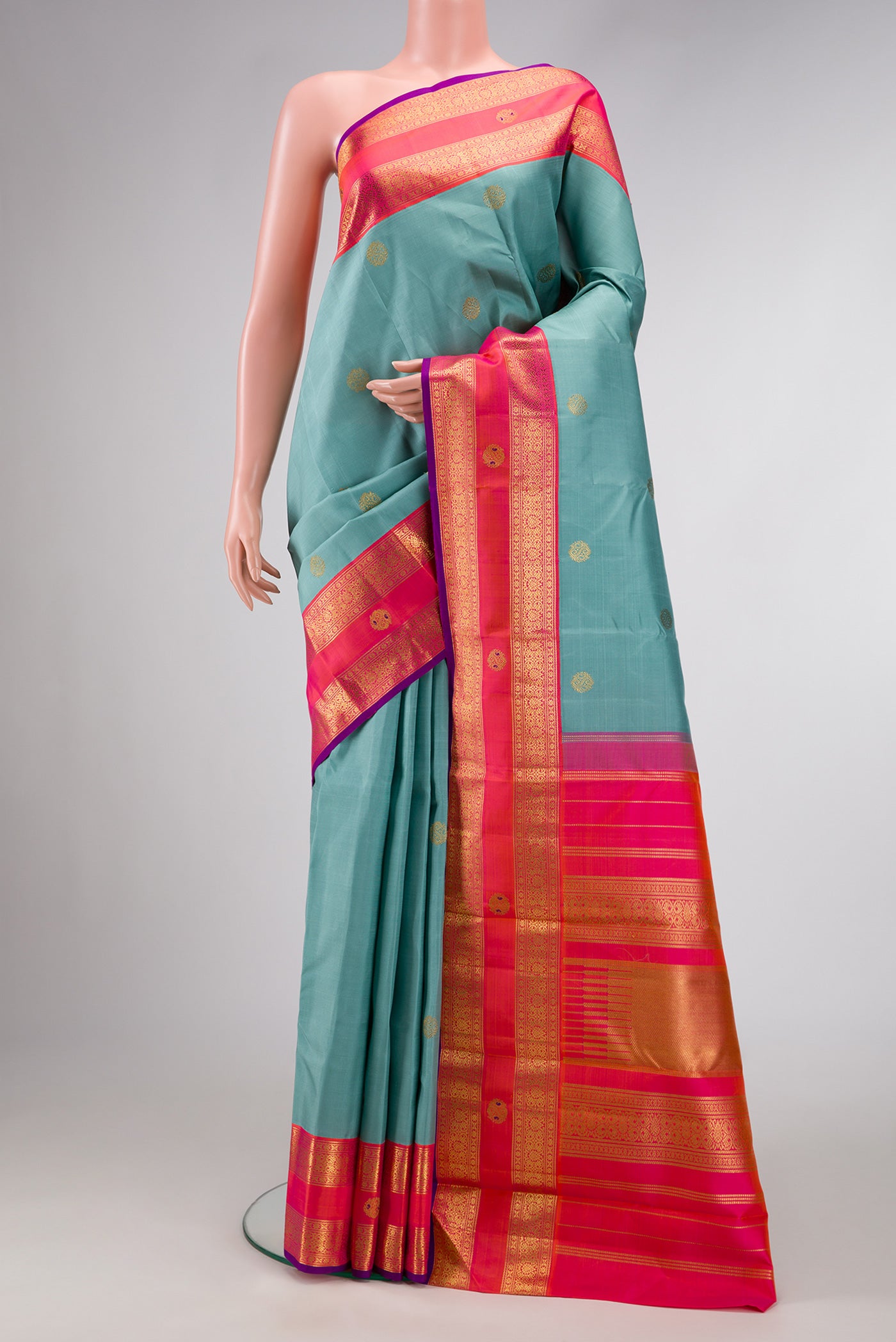 Pure Silk Pure Zari Sky Blue Dual Tone Kanjivaram Saree with Zari Butta on the body and Zari Border.  displayed on a mannequin