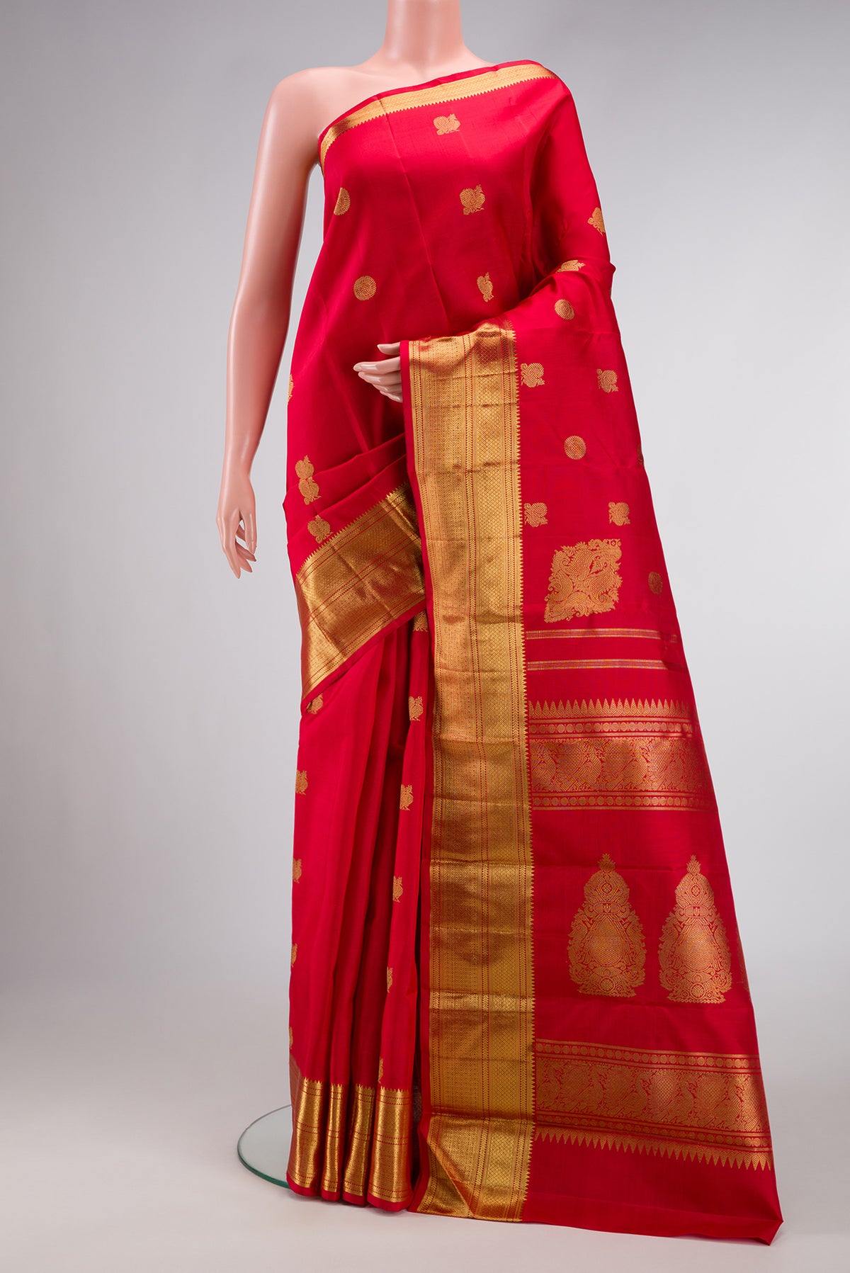 Red Dual Tone Kanjivaram Silk Saree with Zari Butta on the body and Zari Border.  displayed on a mannequin
