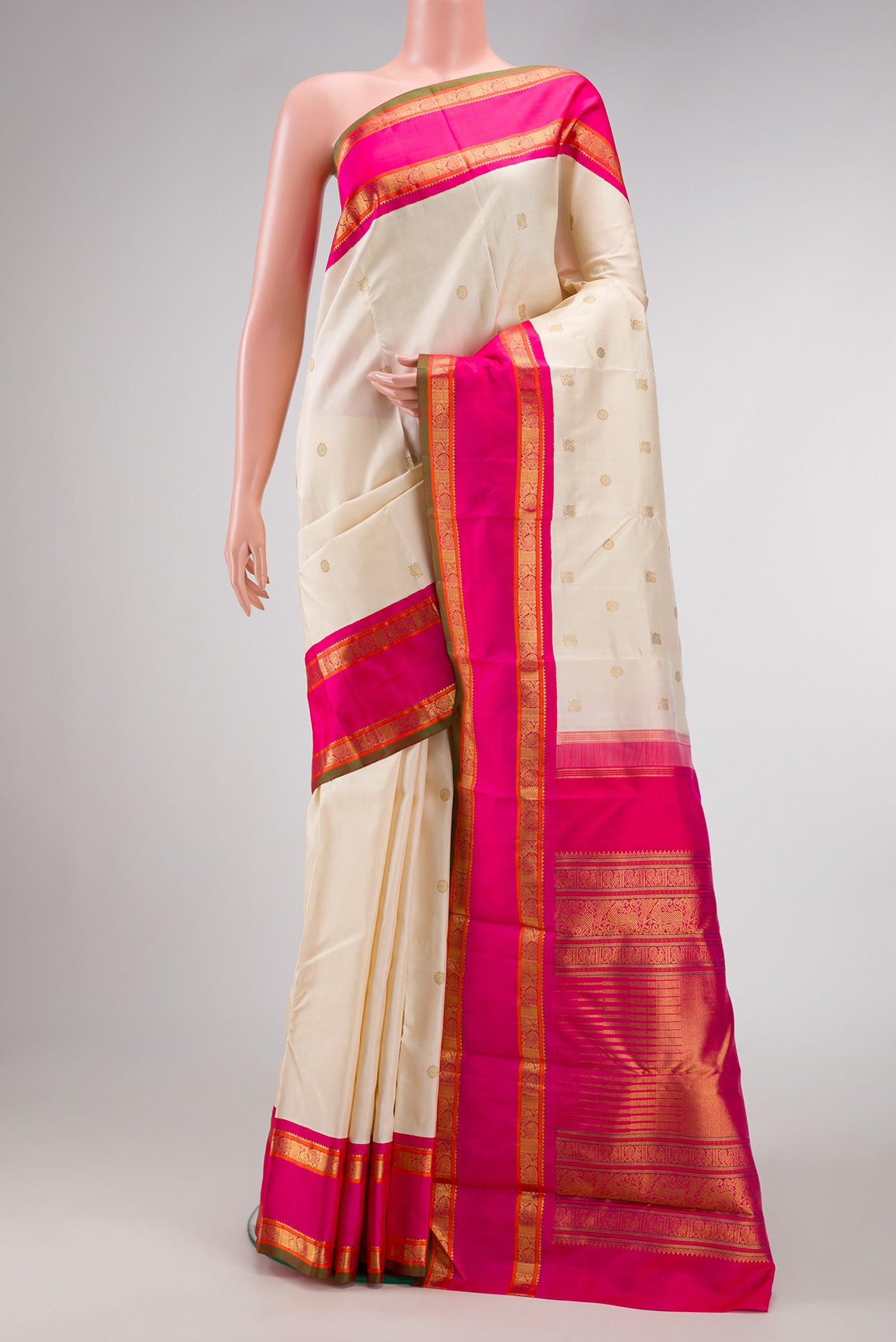 Pure Silk Pure Zari Off White Dual Tone Kanjivaram Saree with Zari Butta on the body and Zari Border.  displayed on a mannequin