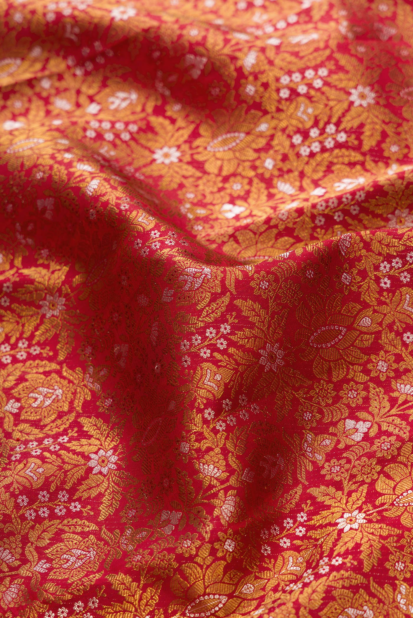 Close up of Red Dual Tone Kanjivaram Silk Saree with Zari Brocade on the body and Zari Border.  displaying folds