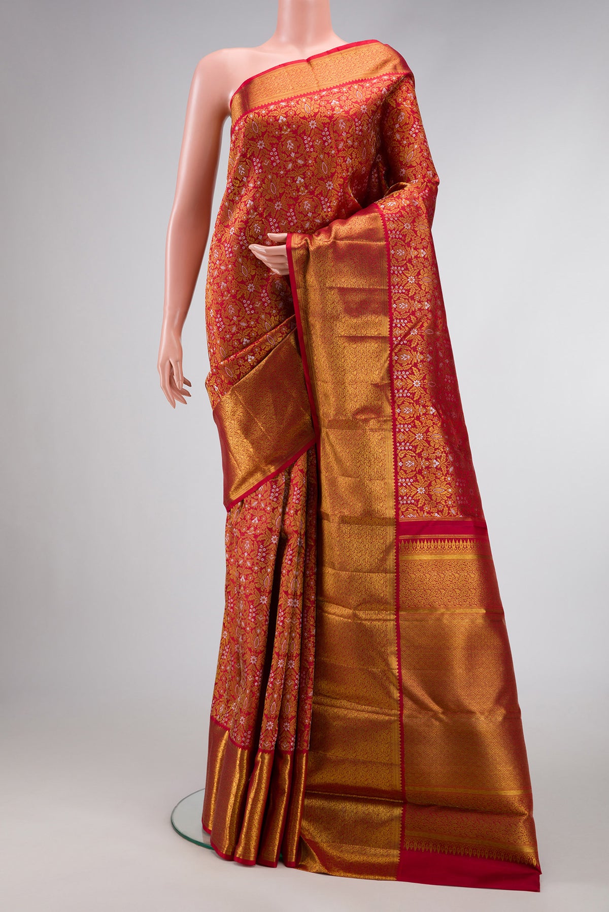 Red Dual Tone Kanjivaram Silk Saree with Zari Brocade on the body and Zari Border.  displayed on a mannequin