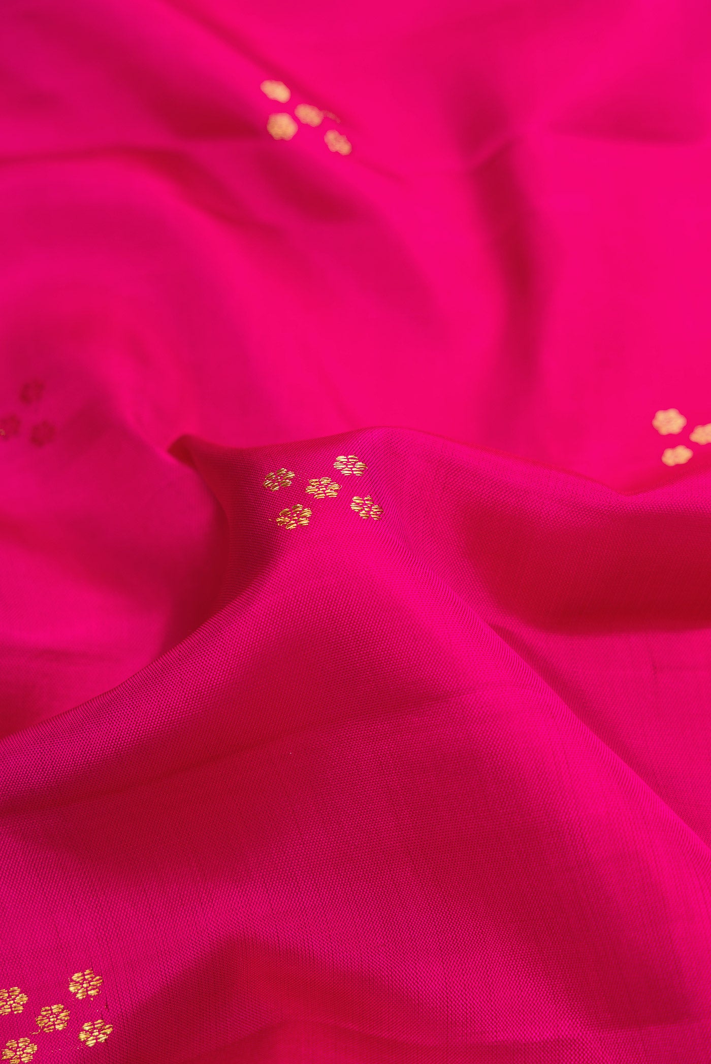 Close up of Pure Silk Pure Zari Pink Dual Tone Kanchipuram Saree with Zari Butta on the body and Fancy Border.  displaying folds