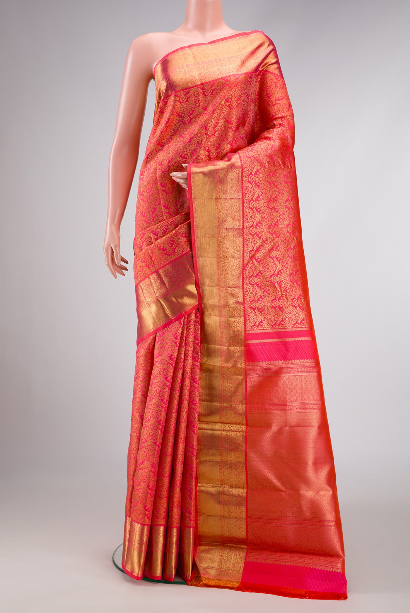 Pure Silk Pure Zari Coral Dual Tone Kanjivaram Saree with Zari Brocade on the body and Zari Border.  displayed on a mannequin