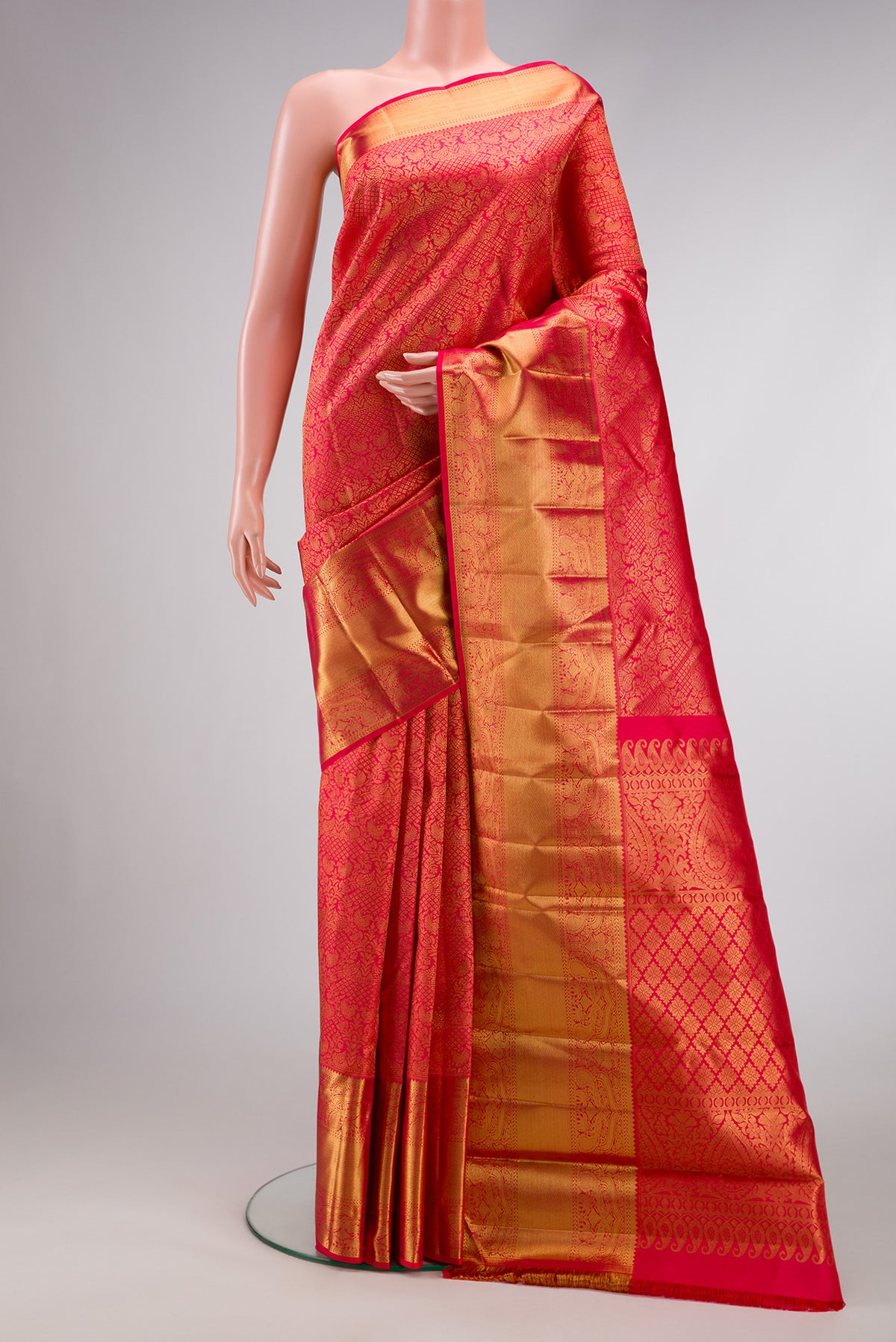 Pure Silk Pure Zari Red Dual Tone Kanjivaram Saree with Zari Brocade on the body and Zari Border.  displayed on a mannequin