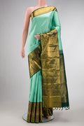 Light Green Dual Tone Kanjivaram Silk Saree with Zari Brocade on the body and Zari Border.  displayed on a mannequin
