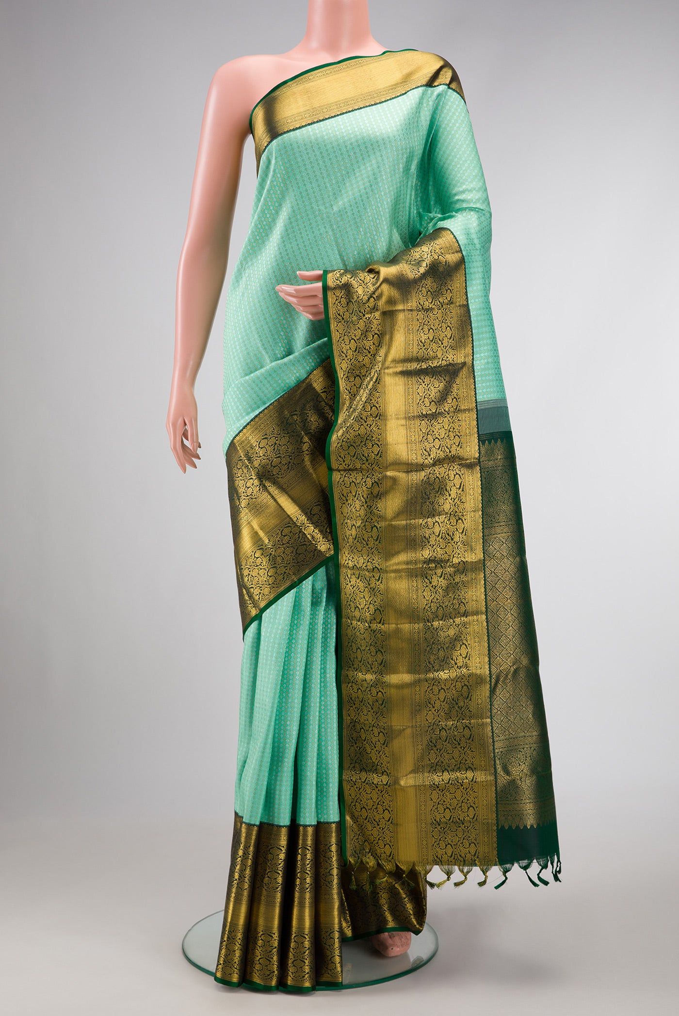 Light Green Dual Tone Kanjivaram Silk Saree with Zari Brocade on the body and Zari Border.  displayed on a mannequin