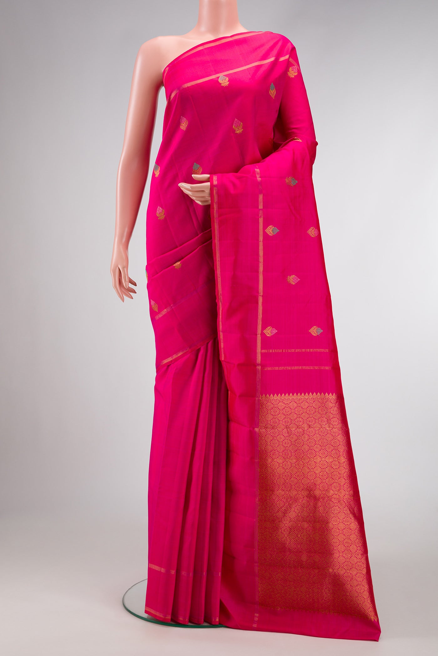 Pure Silk Pure Zari Pink Dual Tone Kanjivaram Saree with Zari And Thread Butta on the body and Zari Border.  displayed on a mannequin