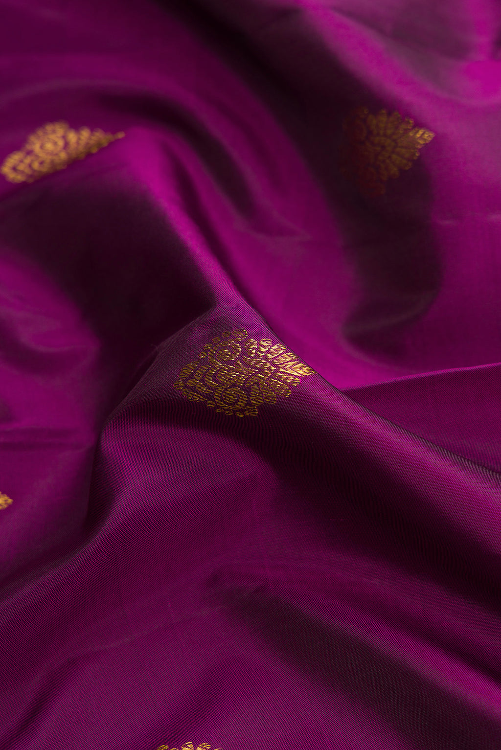Close up of Purple Dual Tone Kanjivaram Silk Saree with Zari Butta on the body and Zari Border.  displaying folds