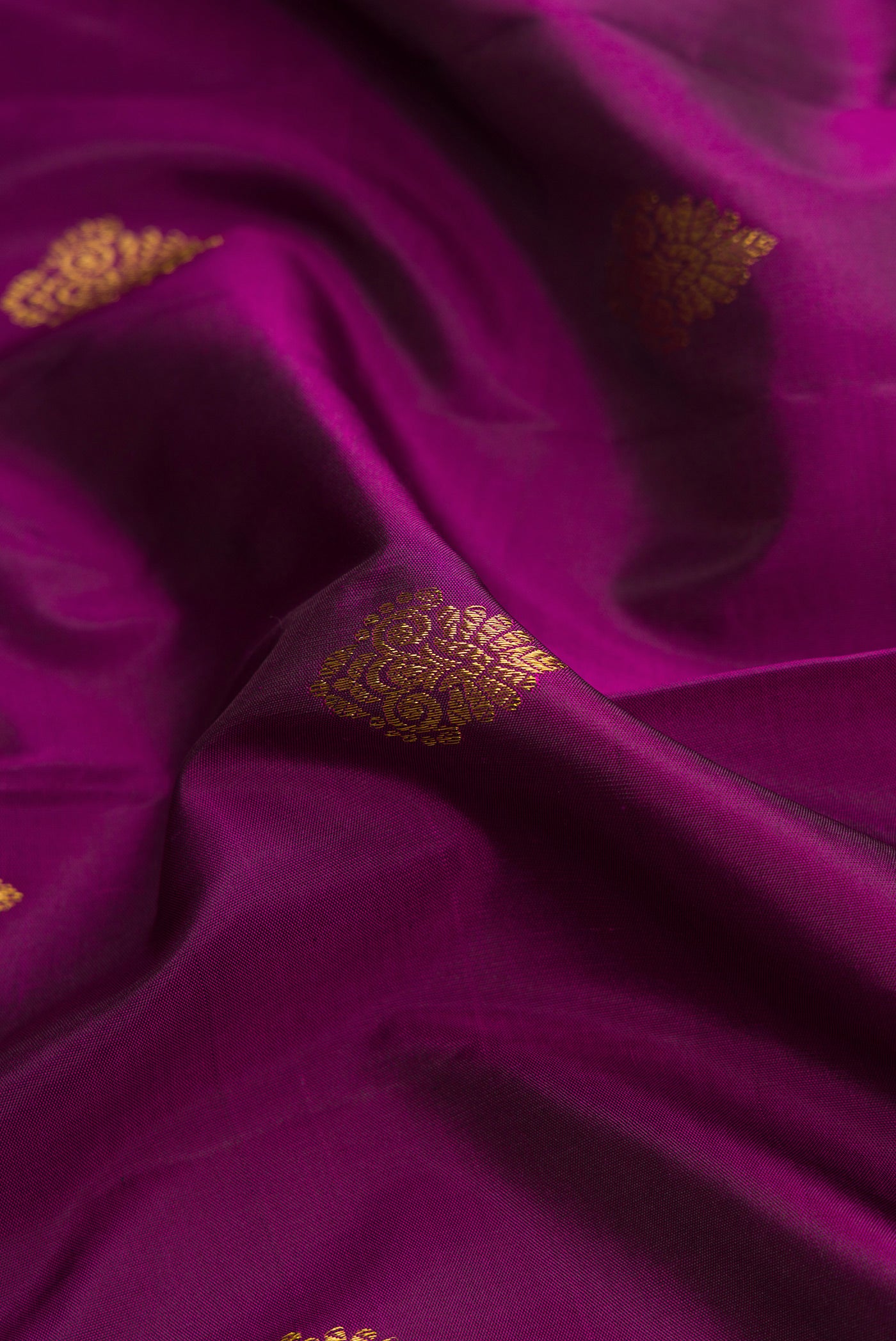 Close up of Purple Dual Tone Kanjivaram Silk Saree with Zari Butta on the body and Zari Border.  displaying folds