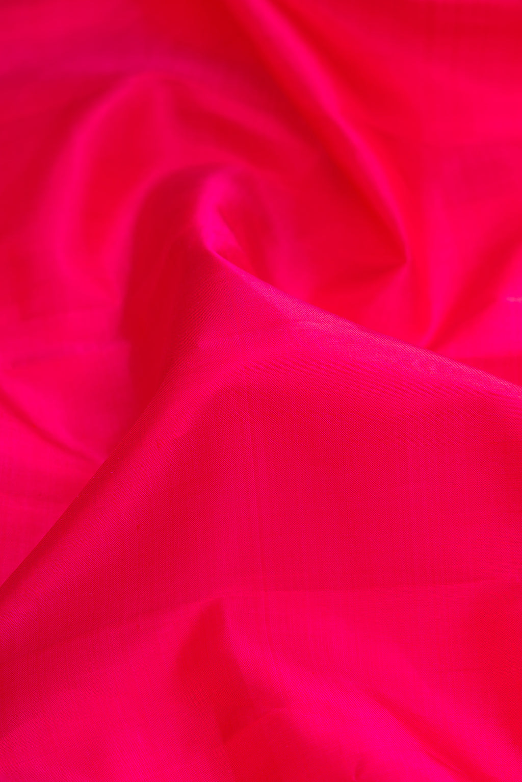 Close up of Pink Dual Tone Kanjivaram Silk Saree with Plain Body and Zari Border.  displaying folds