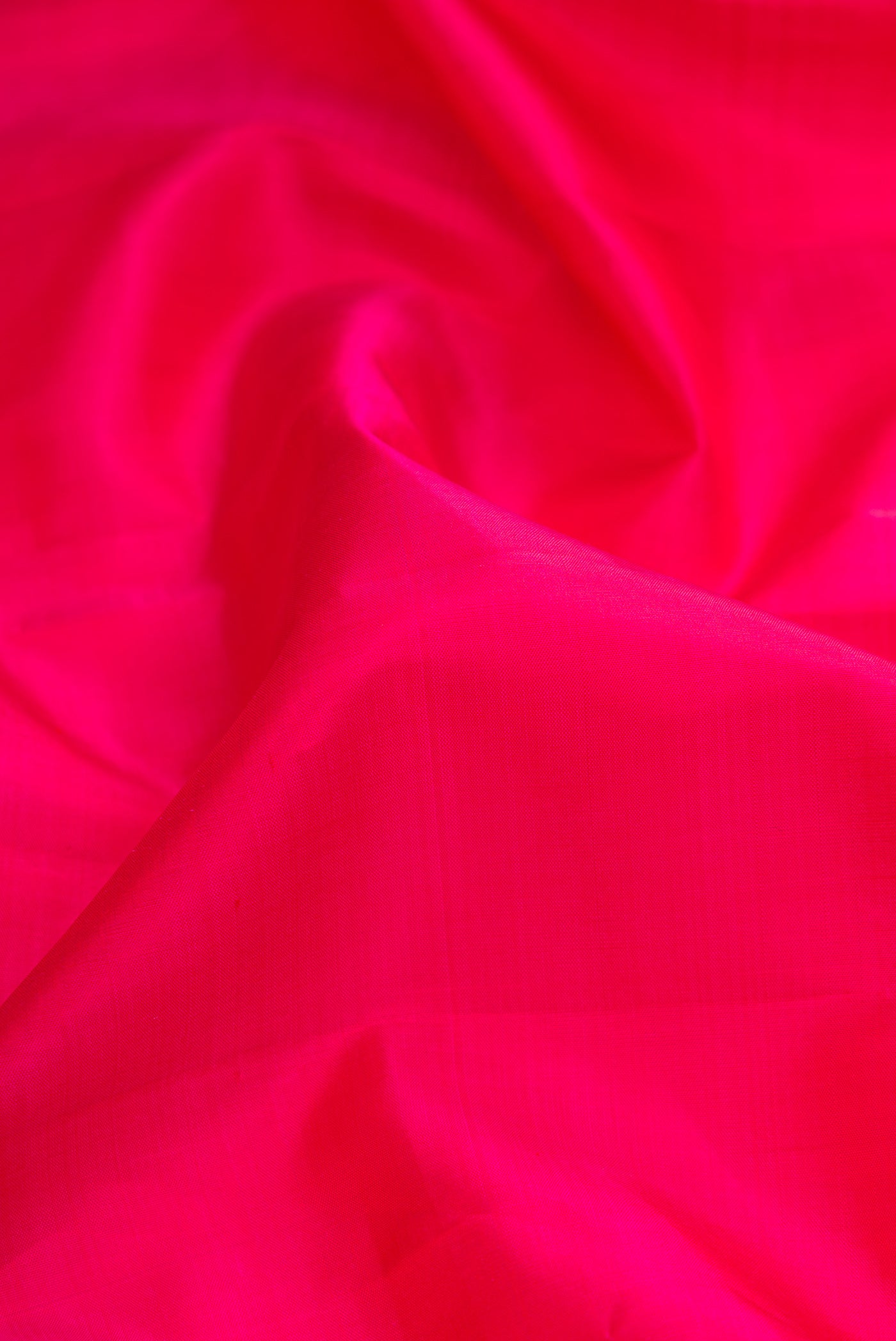 Close up of Pink Dual Tone Kanjivaram Silk Saree with Plain Body and Zari Border.  displaying folds