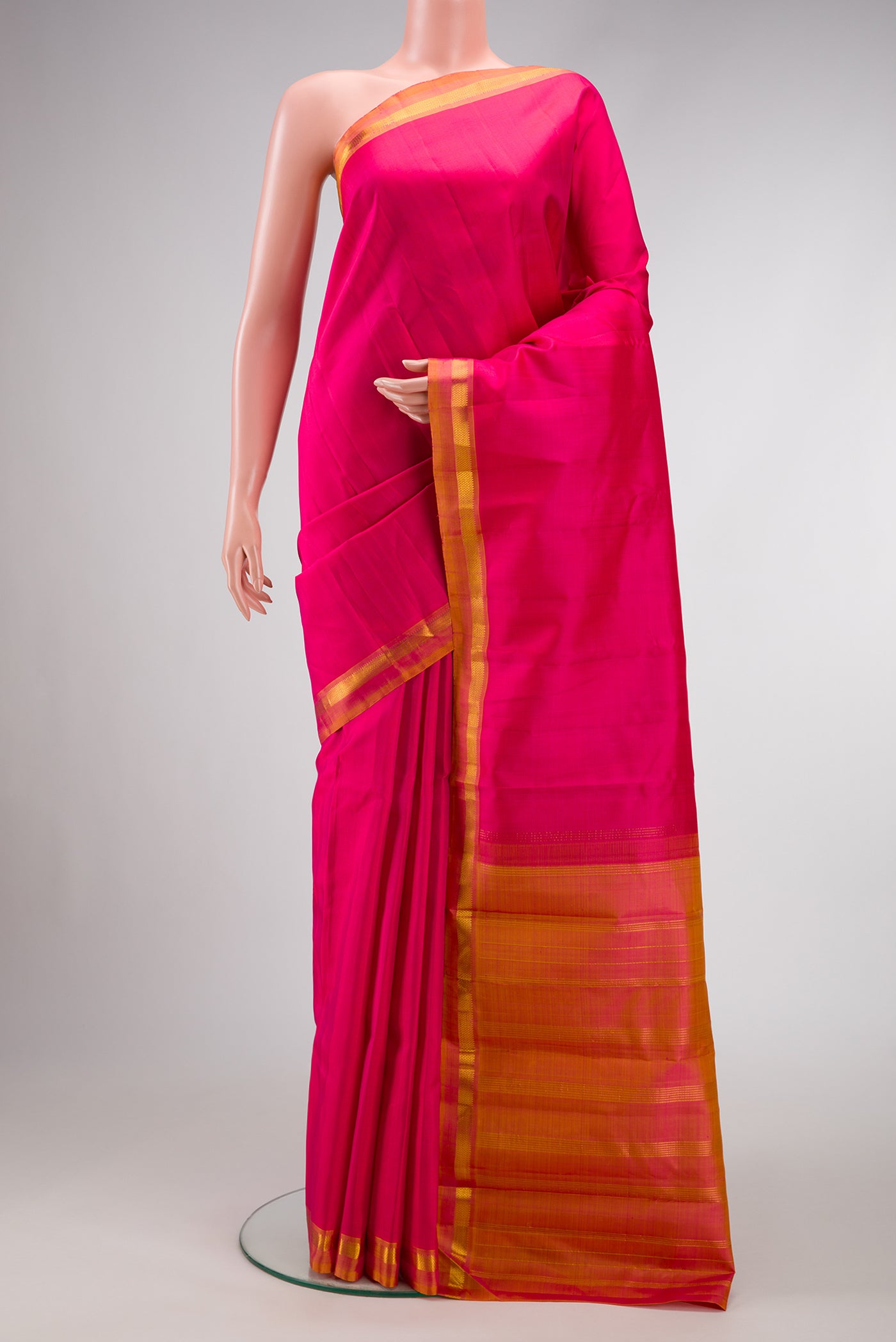 Pink Dual Tone Kanjivaram Silk Saree with Plain Body and Zari Border.  displayed on a mannequin