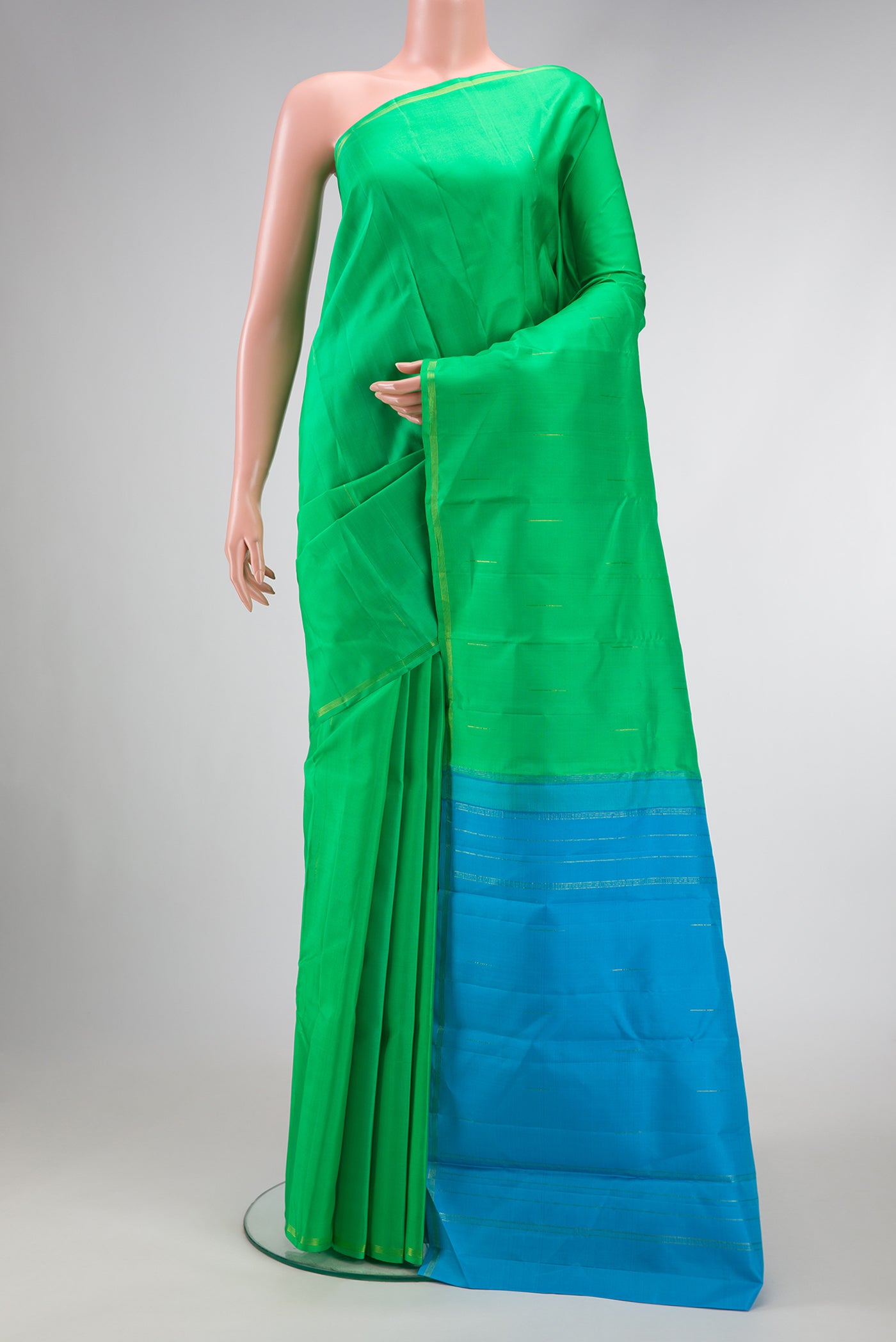 Parrot Green Dual Tone Kanjivaram Silk Saree with Zari Butta on the body and Zari Border.  displayed on a mannequin