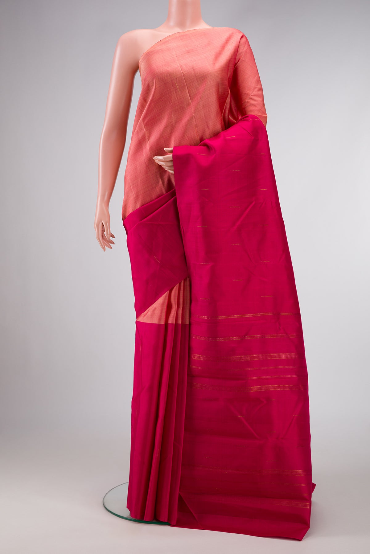 Peach and Dark Pink Color Kanjivaram Silk Saree with Half And Half on the body and Without Border.  displayed on a mannequin