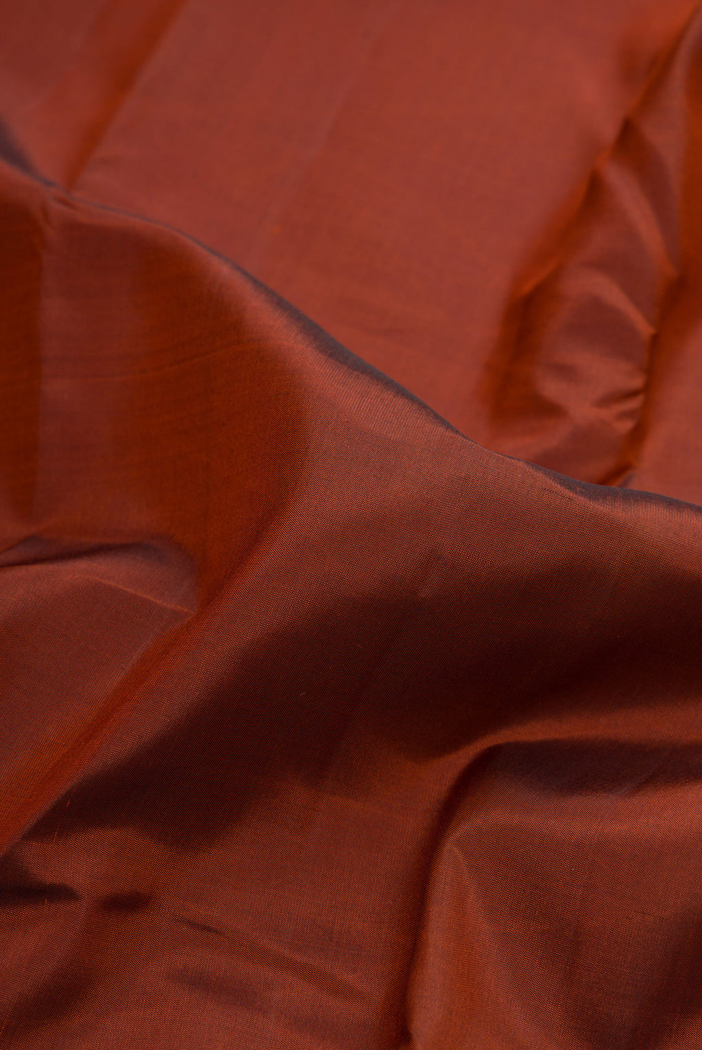 Close up of Brown Dual Tone Kanchipuram Silk Saree with Plain Body and Temple Border.  displaying folds