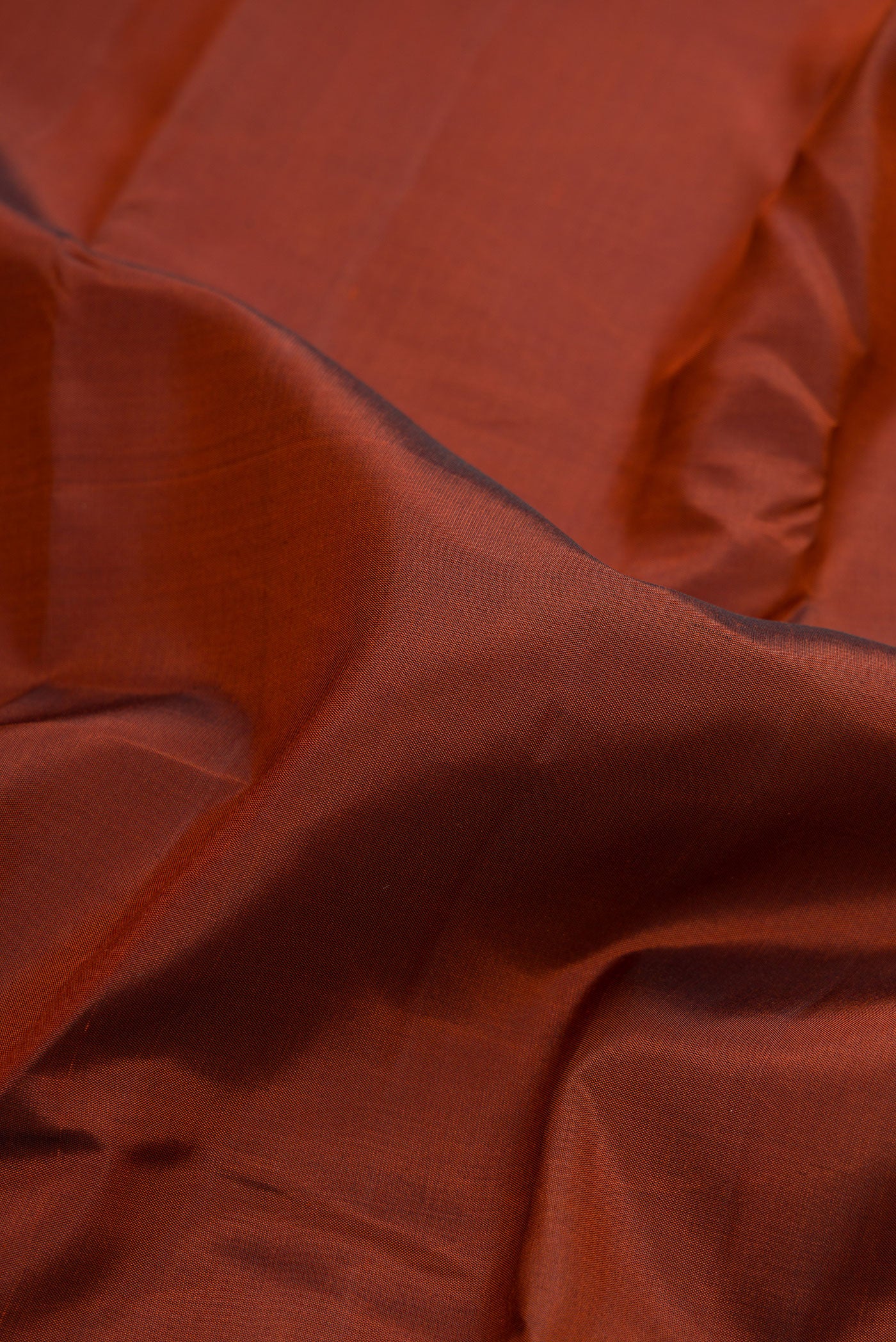 Close up of Brown Dual Tone Kanchipuram Silk Saree with Plain Body and Temple Border.  displaying folds