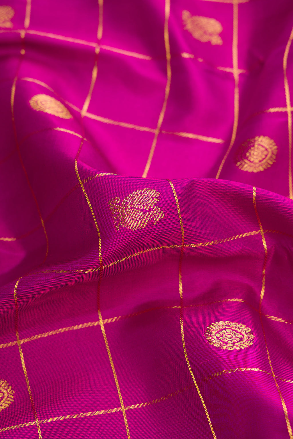 Close up of Pure Silk Pure Zari Purple Dual Tone Kanjivaram Saree with Checked design on the body and Zari Border.  displaying folds