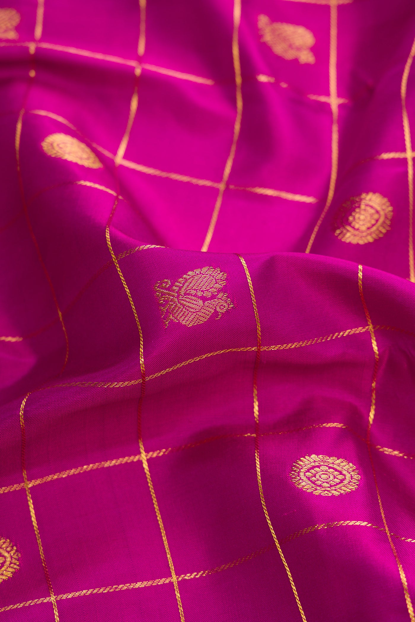 Close up of Pure Silk Pure Zari Purple Dual Tone Kanjivaram Saree with Checked design on the body and Zari Border.  displaying folds