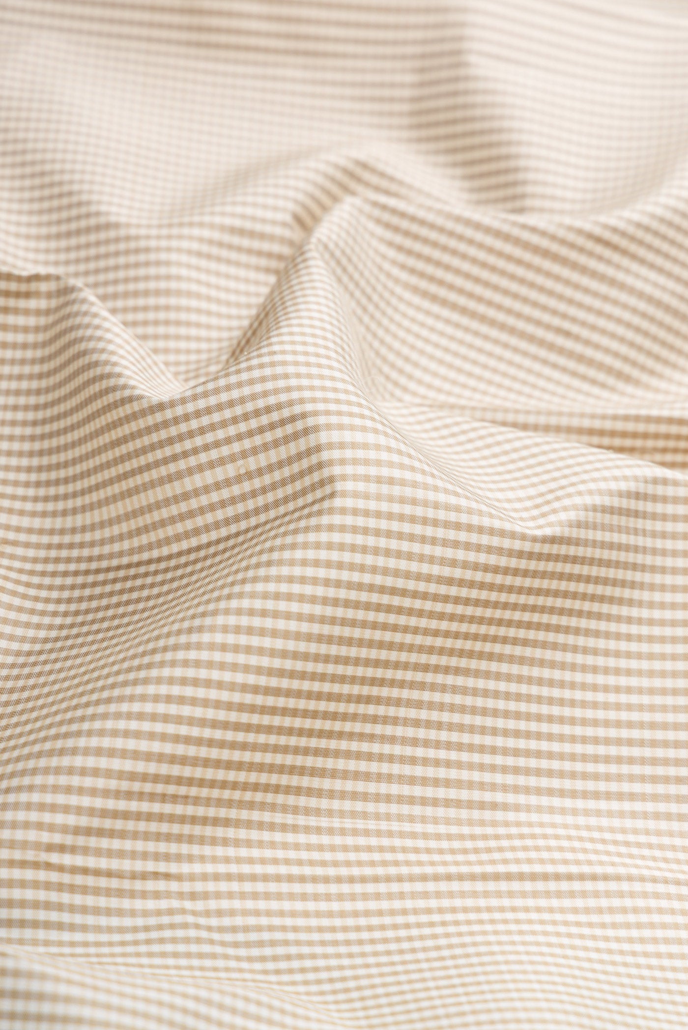 Close up of Beige Dual Tone Kanjivaram Silk Saree with Checked design on the body and Zari Border.  displaying folds