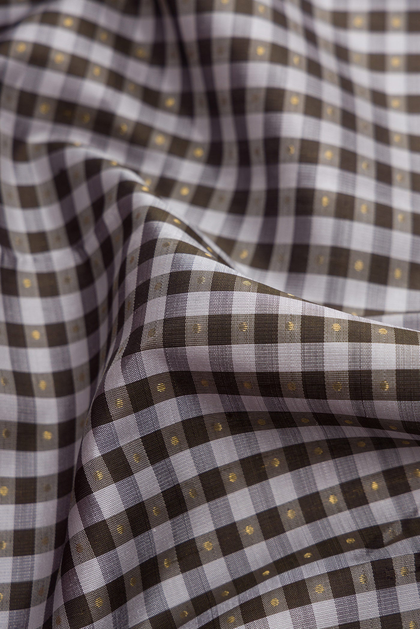 Close up of Pure Silk Pure Zari Grey Dual Tone Kanjivaram Saree with Checked design on the body and Zari Border.  displaying folds