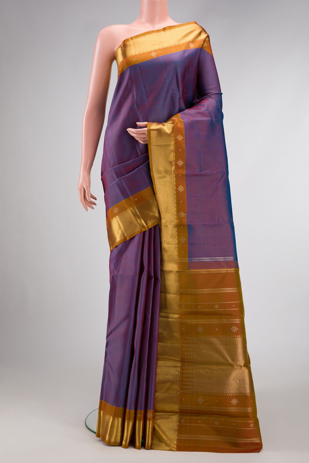 Pure Silk Pure Zari Purple Dual Tone Kanjivaram Saree with Stripes on the body and Zari Border.  displayed on a mannequin