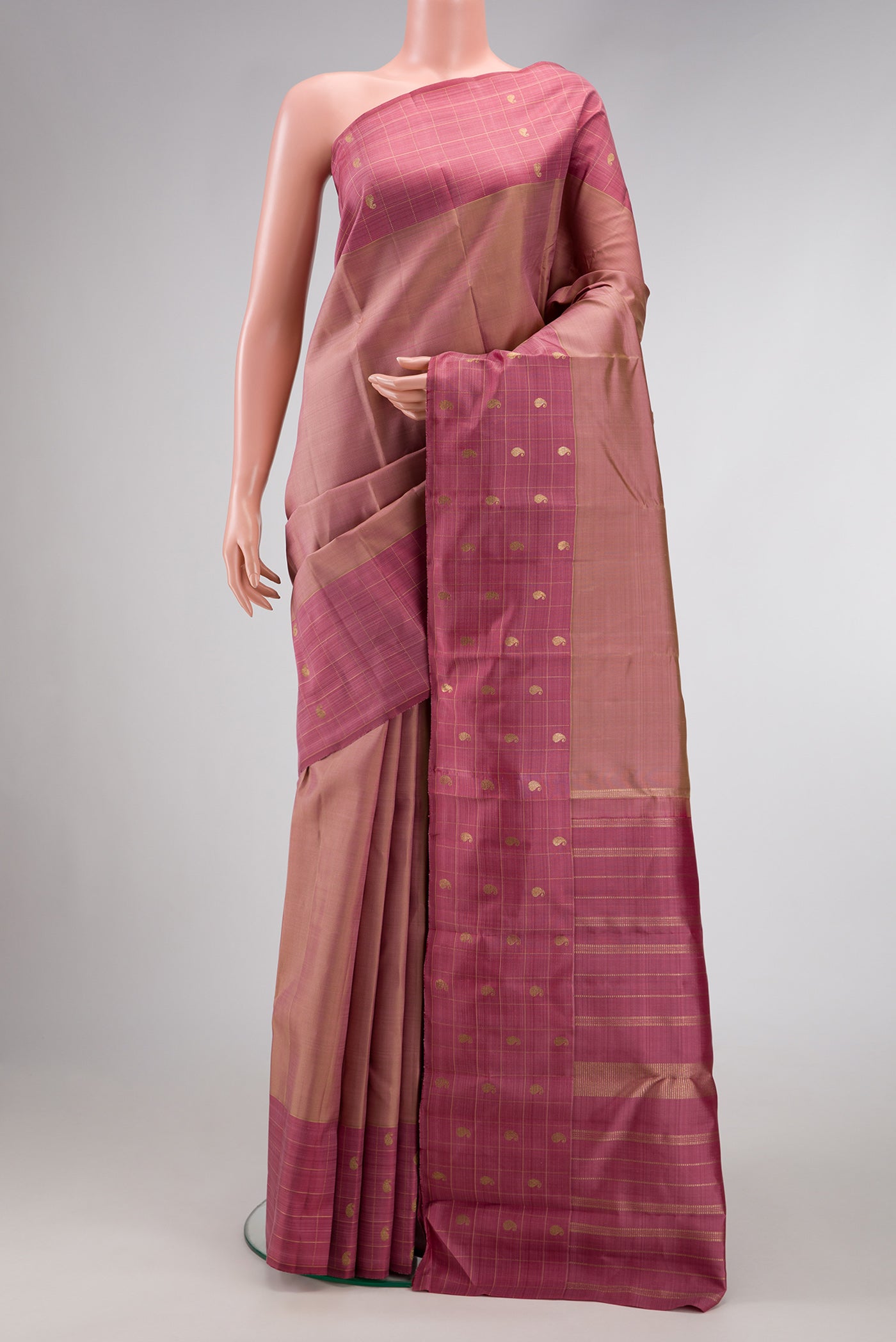 Pure Silk Pure Zari Rose Gold Dual Tone Kanchipuram Saree with Zari Butta on the body and Zari Border.  displayed on a mannequin