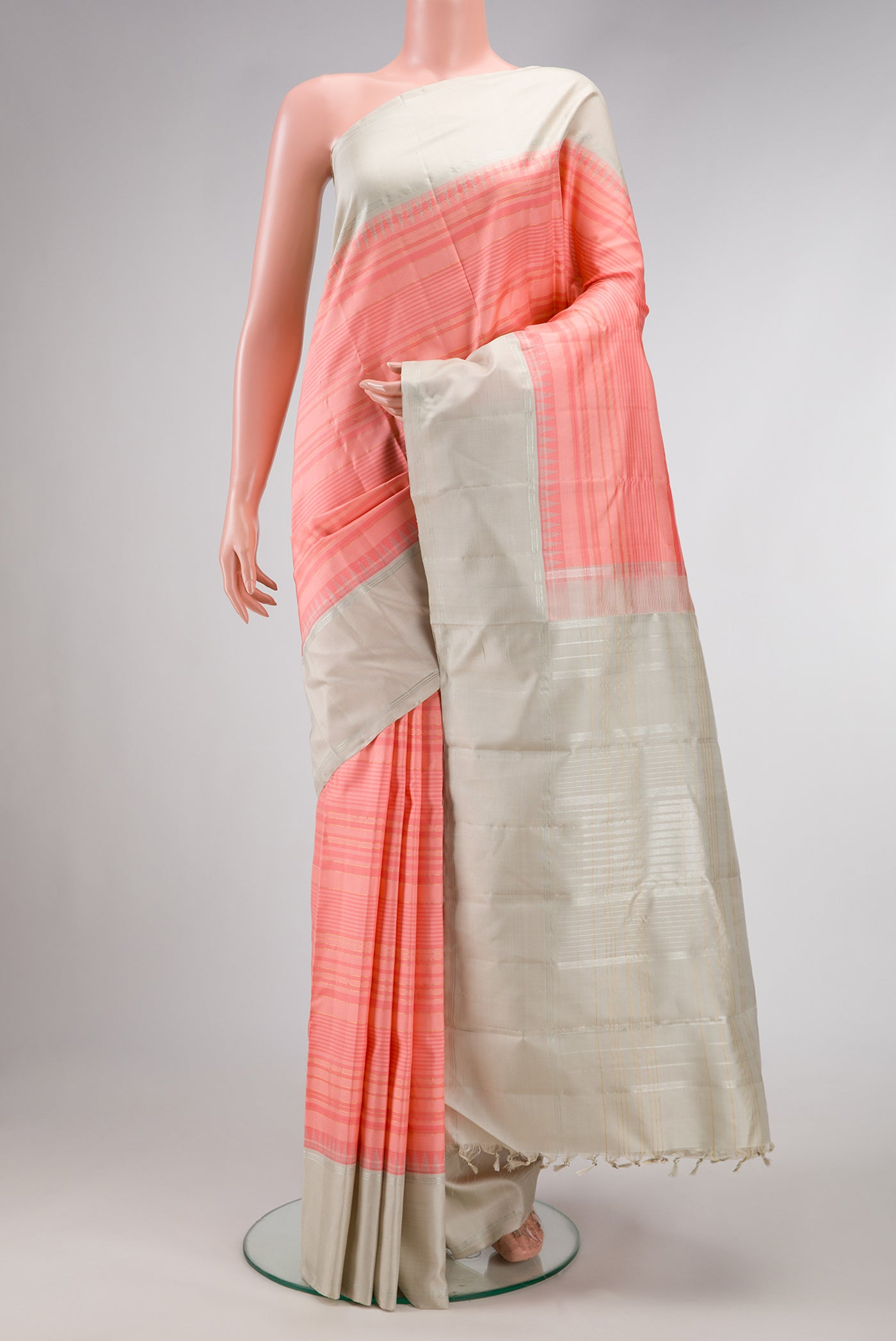 Peach Dual Tone Kanjivaram Silk Saree with Stripes on the body and Zari Border.  displayed on a mannequin
