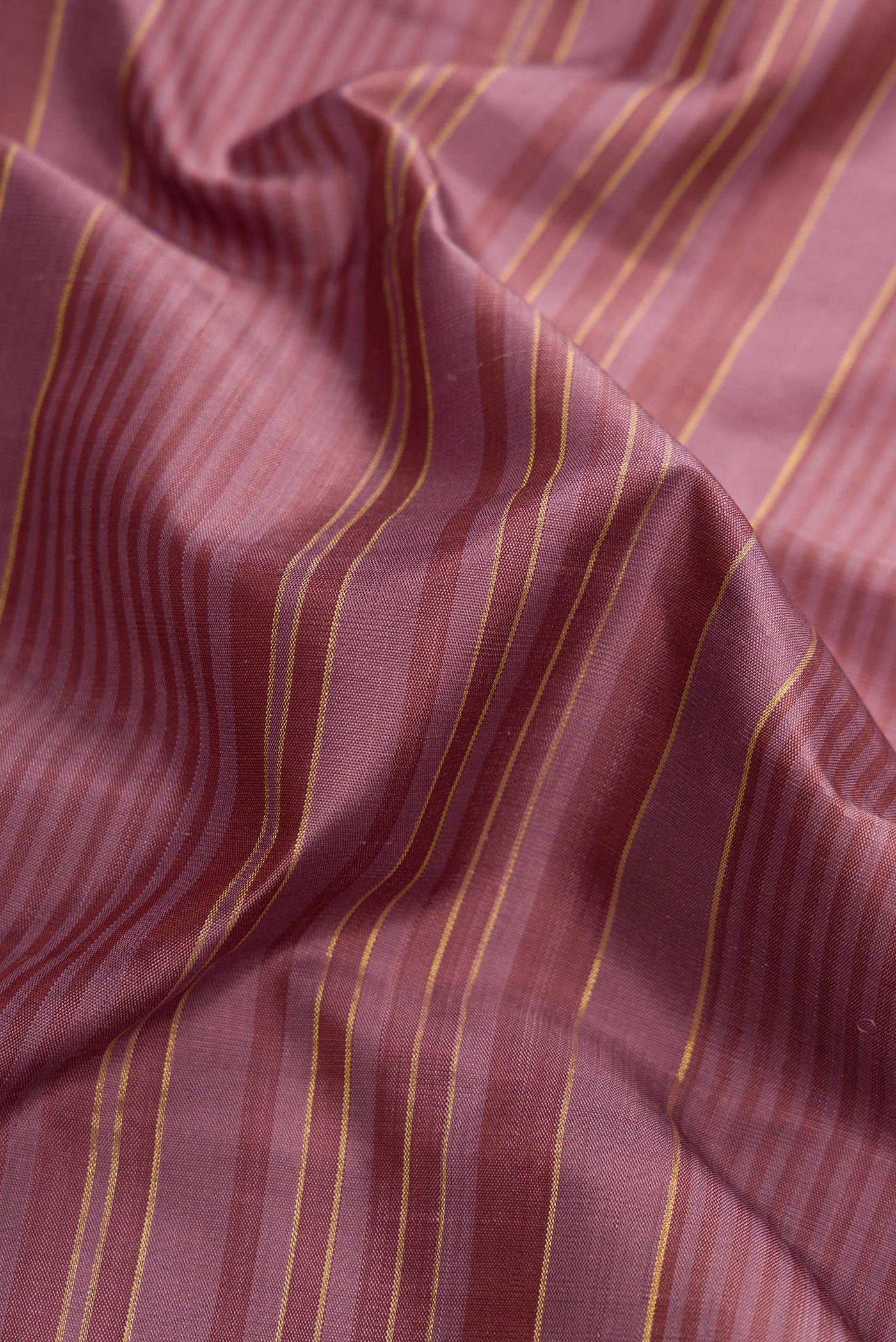 Close up of Purple Dual Tone Kanjivaram Silk Saree with Stripes on the body and Zari Border.  displaying folds