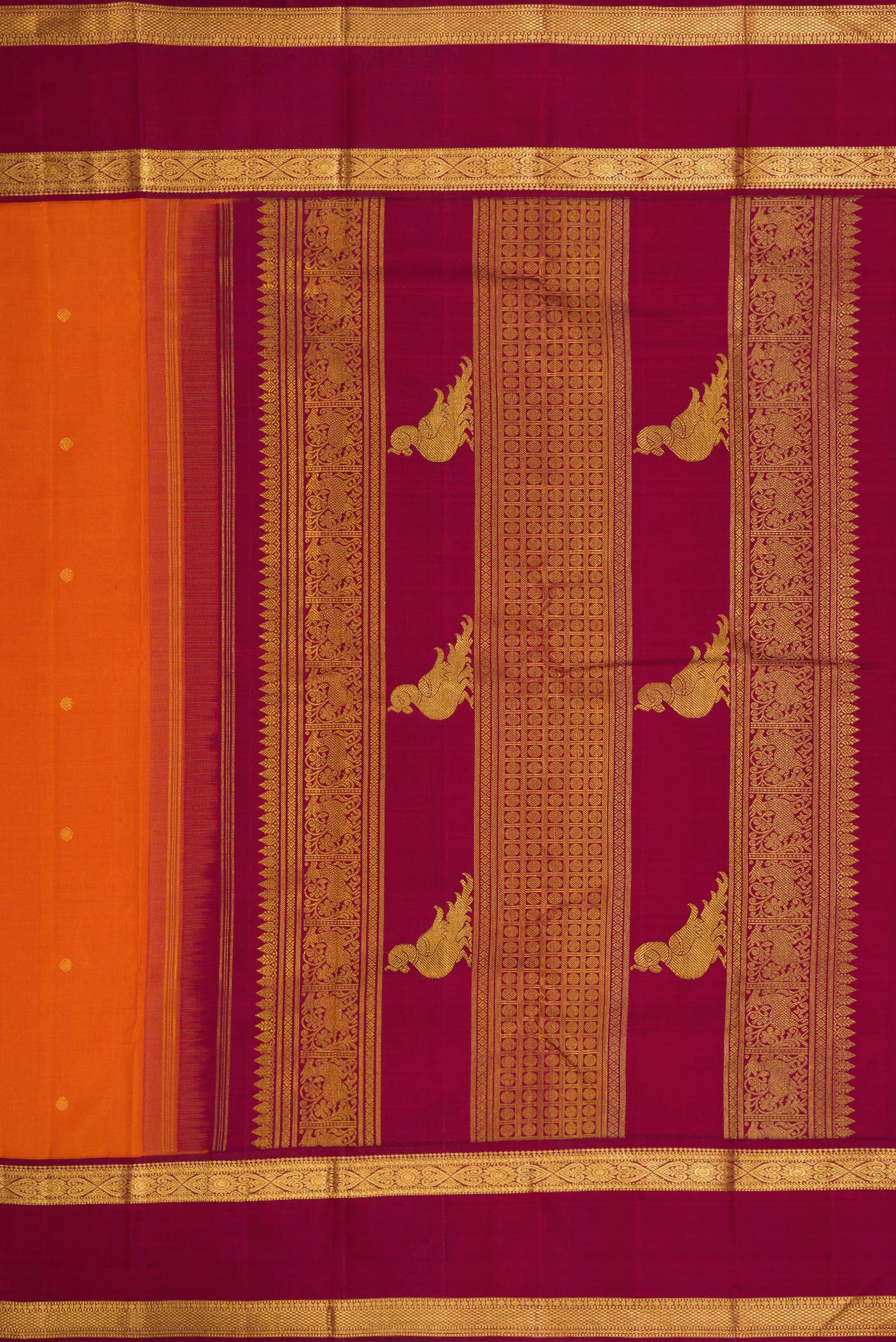 Close up image of the pallu of Pure Silk Pure Zari Brick Orange Dual Tone Kanjivaram Saree with Zari Butta on the body and Zari Border. 