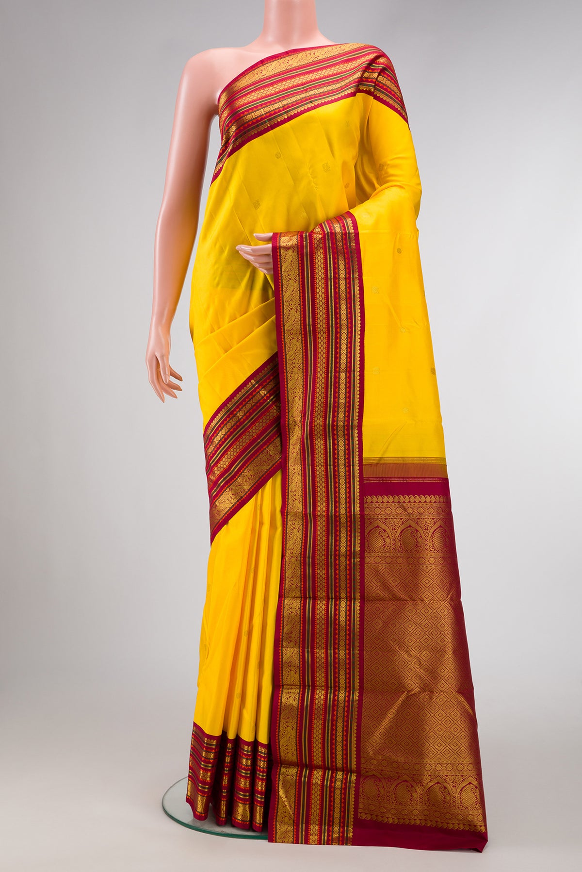 Pure Silk Pure Zari Yellow Dual Tone Kanjivaram Saree with Zari Butta on the body and Zari Border.  displayed on a mannequin