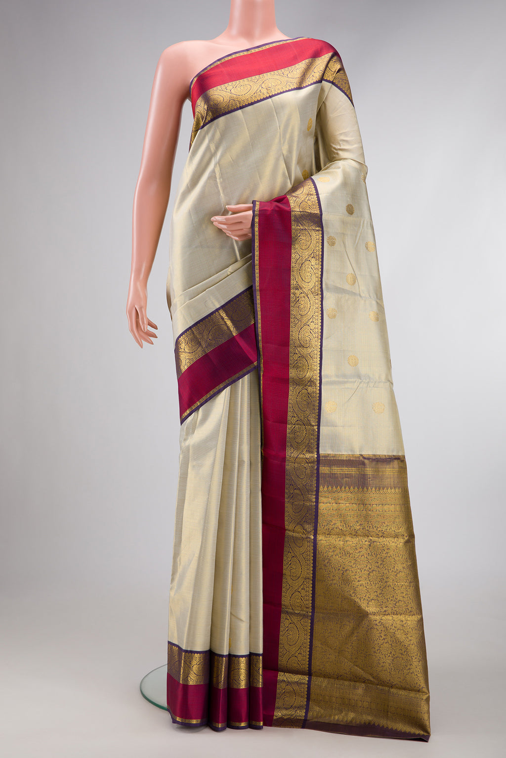 Beige Dual Tone Kanjivaram Silk Saree with Zari Butta on the body and Zari And Thread Border.  displayed on a mannequin