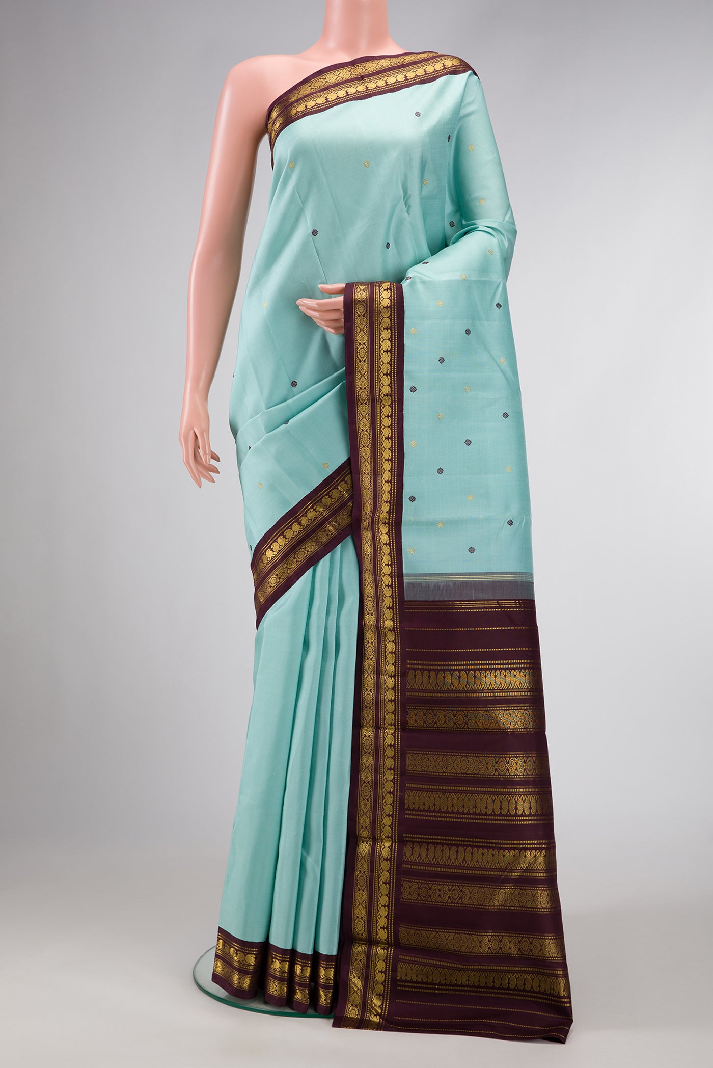 Sky Blue Dual Tone Kanjivaram Silk Saree with Zari And Thread Butta on the body and Zari Border.  displayed on a mannequin
