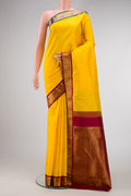 Yellow Dual Tone Kanjivaram Silk Saree with Zari Butta on the body and Ganga Jamuna Border.  displayed on a mannequin