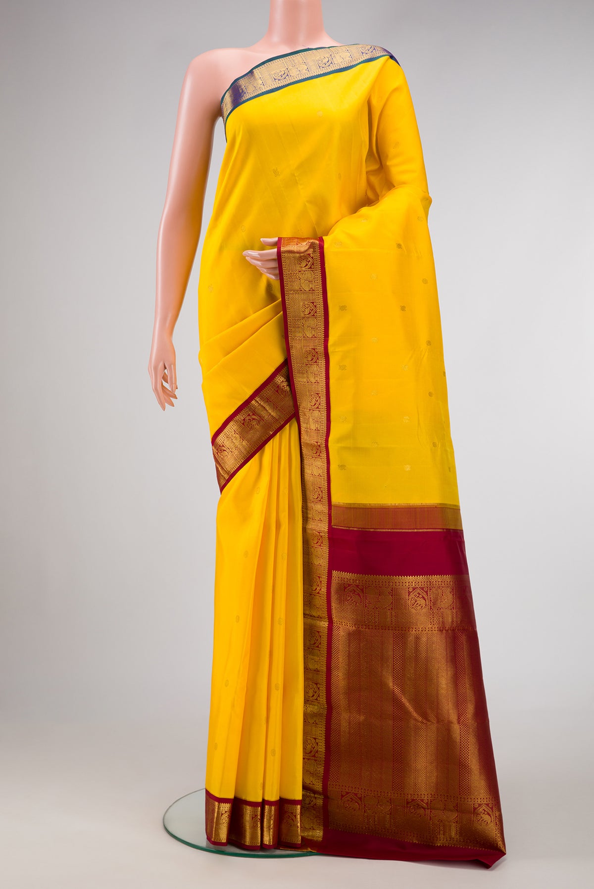 Yellow Dual Tone Kanjivaram Silk Saree with Zari Butta on the body and Ganga Jamuna Border.  displayed on a mannequin