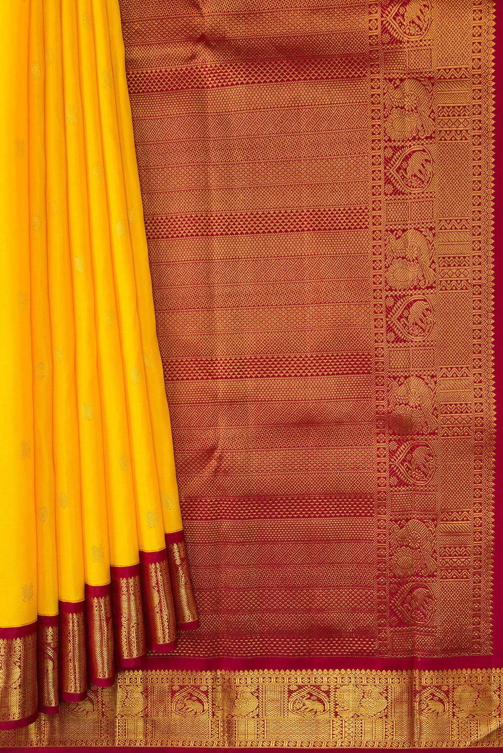 Pleats and pallu of Yellow Dual Tone Kanjivaram Silk Saree with Zari Butta on the body and Ganga Jamuna Border. 