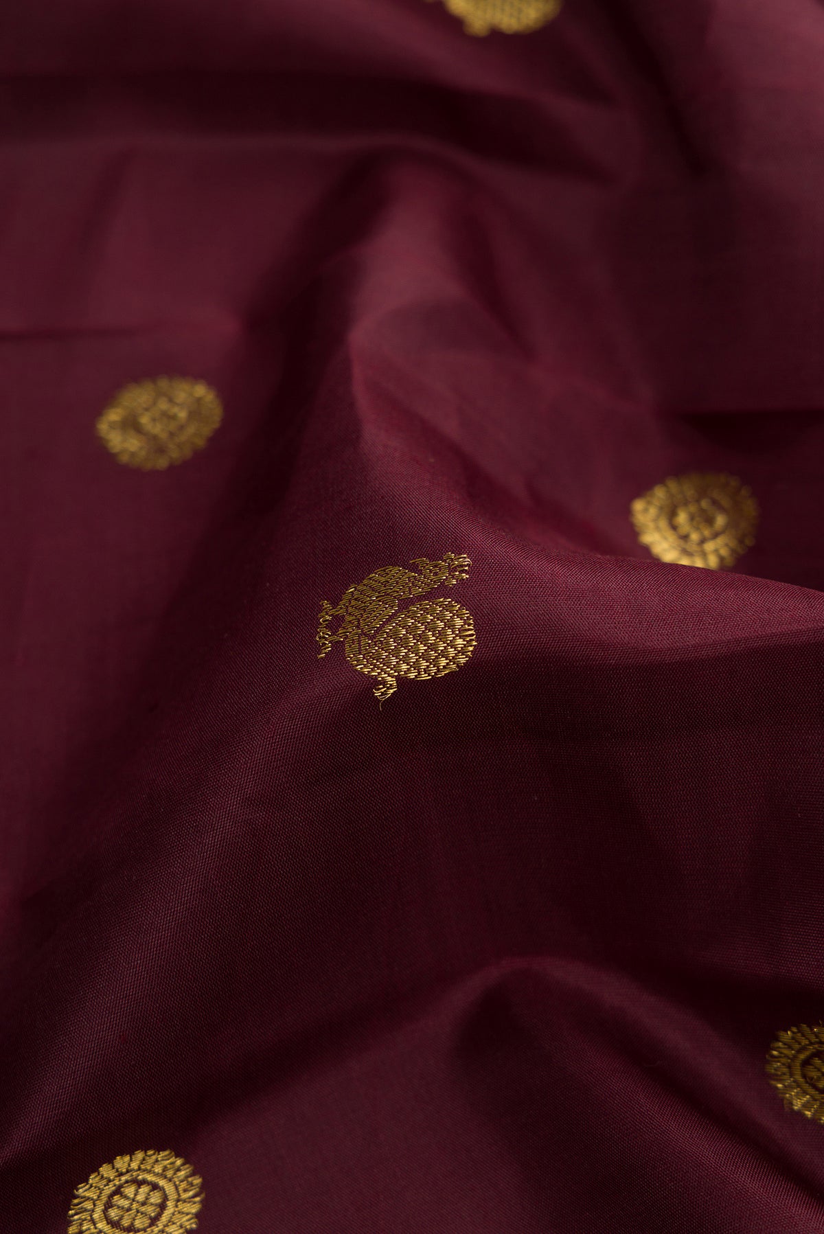 Close up of Coffee Brown Dual Tone Kanjivaram Silk Saree with Zari Butta on the body and Zari Border.  displaying folds