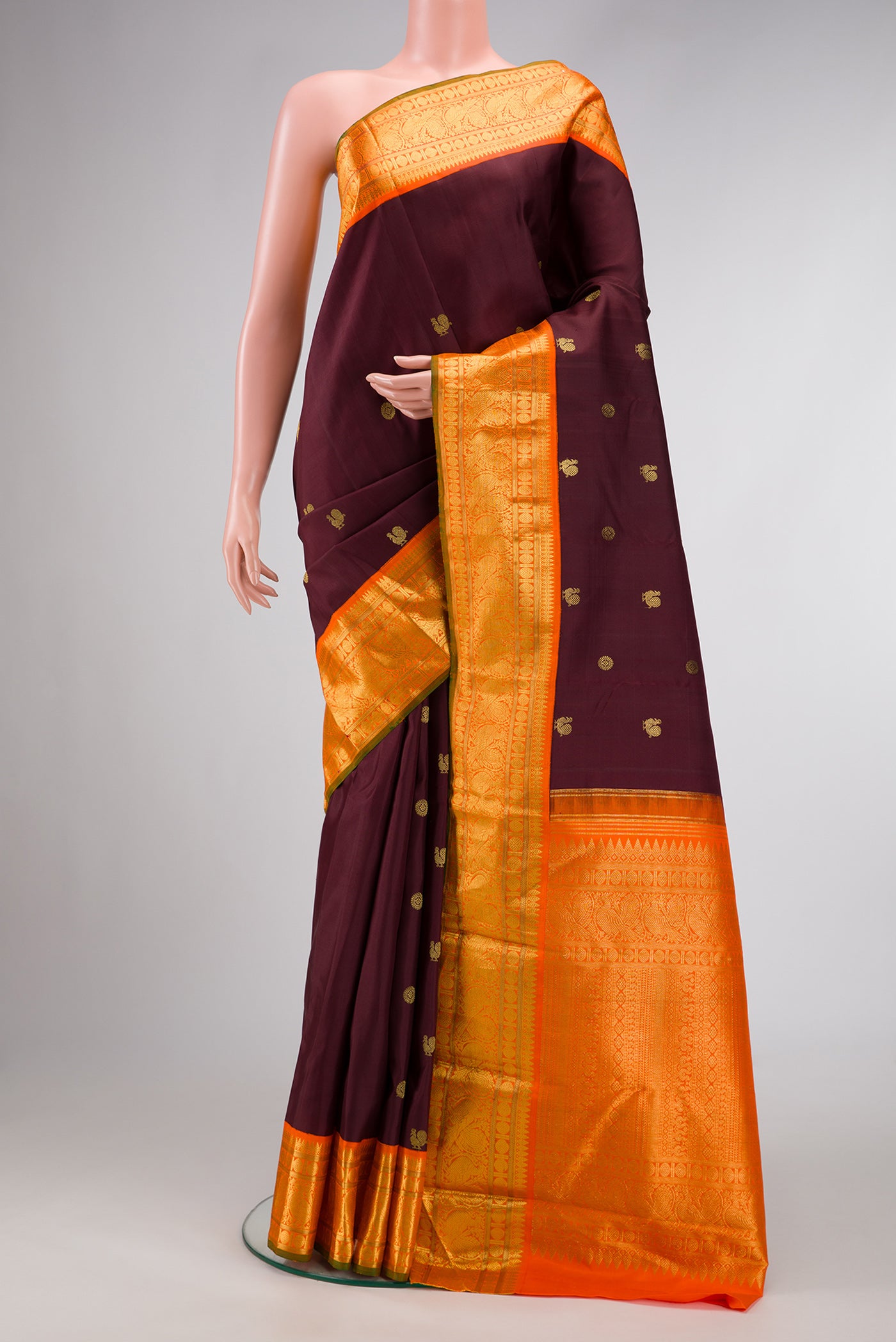 Coffee Brown Dual Tone Kanjivaram Silk Saree with Zari Butta on the body and Zari Border.  displayed on a mannequin