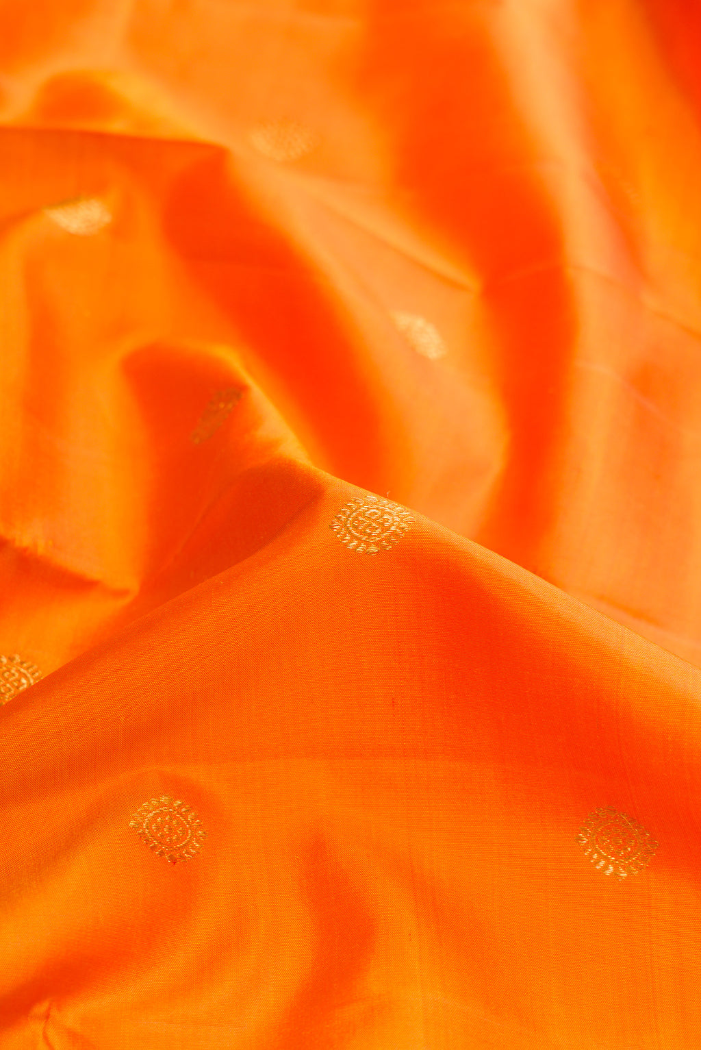 Close up of Mustard Dual Tone Kanjivaram Silk Saree with Zari Butta on the body and Zari Border.  displaying folds